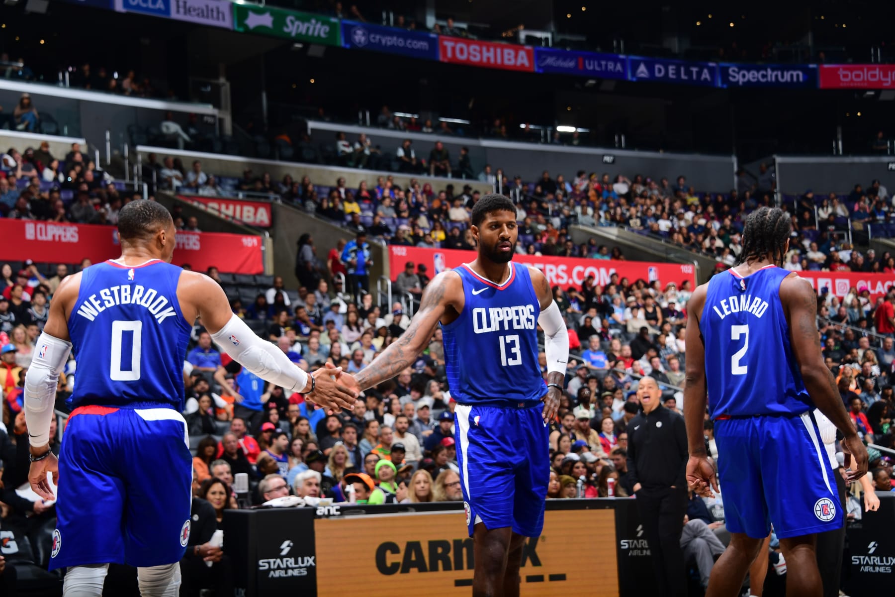 LOS ANGELES, CA - OCTOBER 31: Russell Westbrook #0 of the LA Clippers high five Paul George #13 of the LA Clippers during the game against the Orlando Magic on October 31, 2023 at Crypto.Com Arena in Los Angeles, California. NOTE TO USER: User expressly acknowledges and agrees that, by downloading and/or using this Photograph, user is consenting to the terms and conditions of the Getty Images License Agreement. Mandatory Copyright Notice: Copyright 2023 NBAE (Photo by Adam Pantozzi/NBAE via Getty Images)