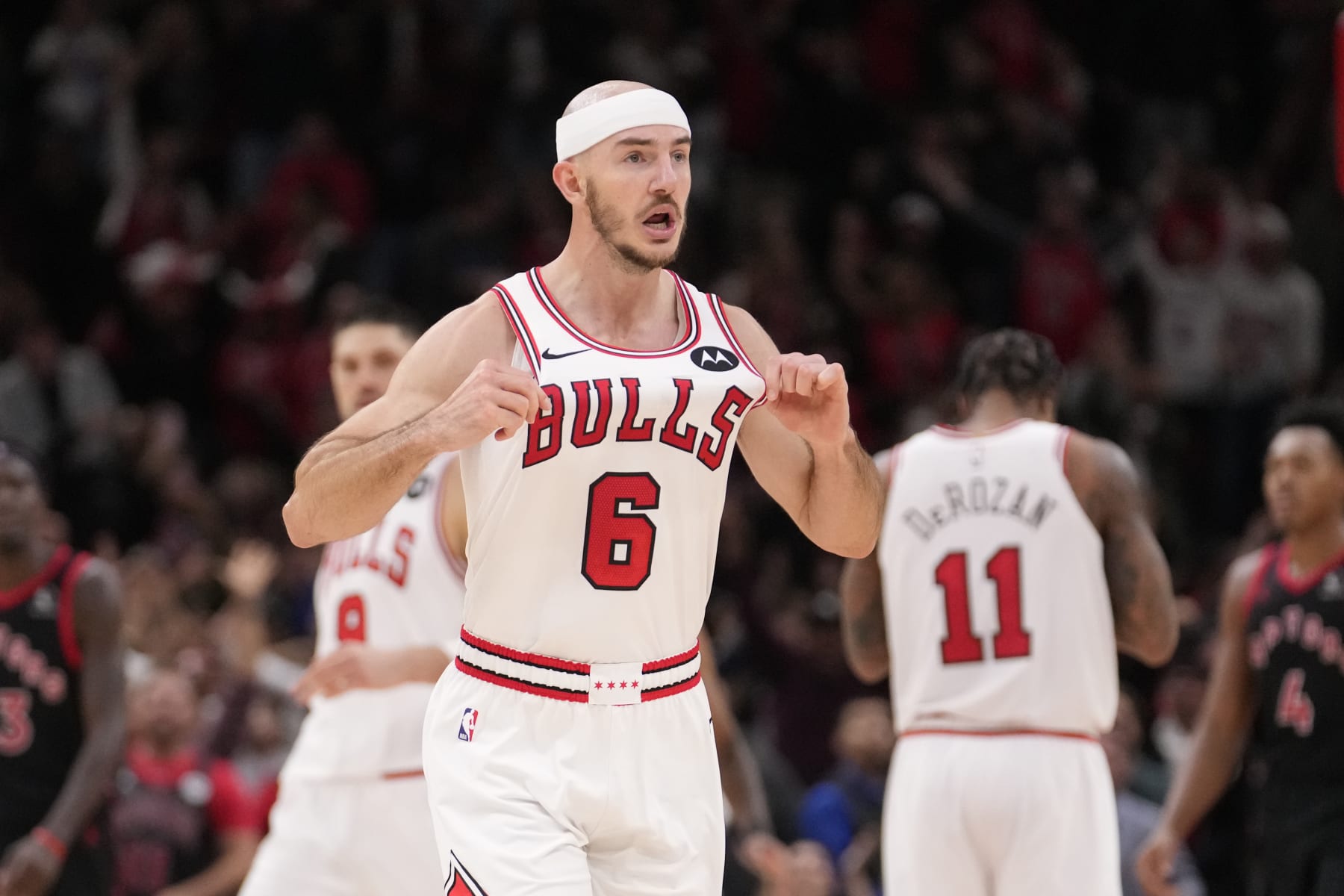 Chicago Bulls' Alex Caruso celebrates his three-point basket with just seconds remaining during an NBA basketball game against the Toronto Raptors Friday, Oct. 27, 2023, in Chicago. (AP Photo/Charles Rex Arbogast)