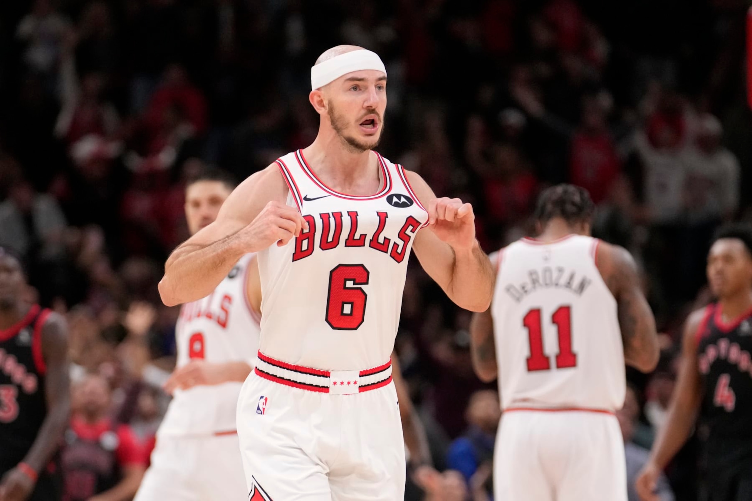 Chicago Bulls' Alex Caruso celebrates his three-point basket with just seconds remaining during an NBA basketball game against the Toronto Raptors Friday, Oct. 27, 2023, in Chicago. (AP Photo/Charles Rex Arbogast)