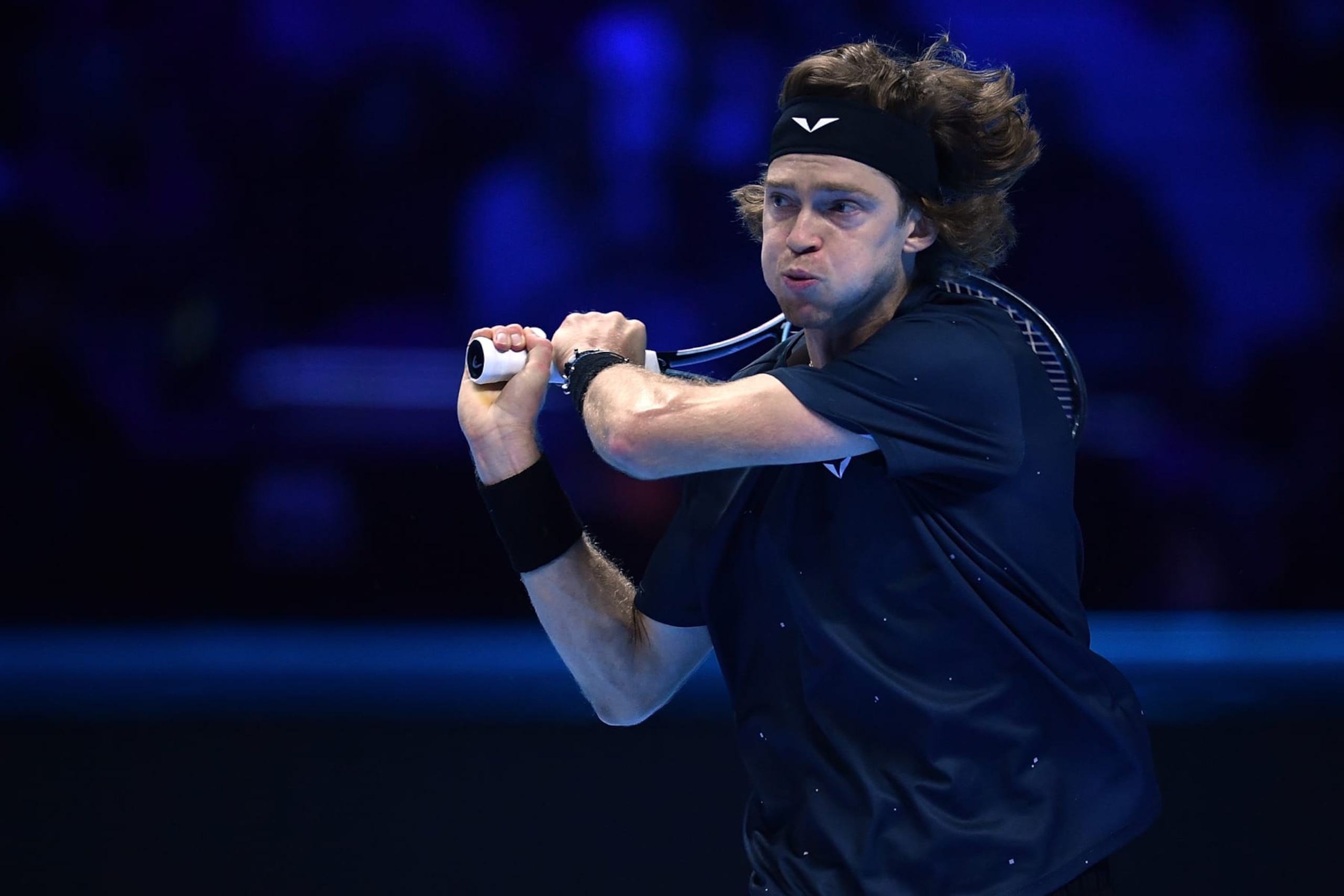 TURIN, ITALY - NOVEMBER 15:  Andrey Rublev of Russia plays a backhand against Carlos Alcaraz of Spain during the Men's Singles Round Robin match on day four of the Nitto ATP Finals at Pala Alpitour on November 15, 2023 in Turin, Italy.  (Photo by Valerio Pennicino/Getty Images)