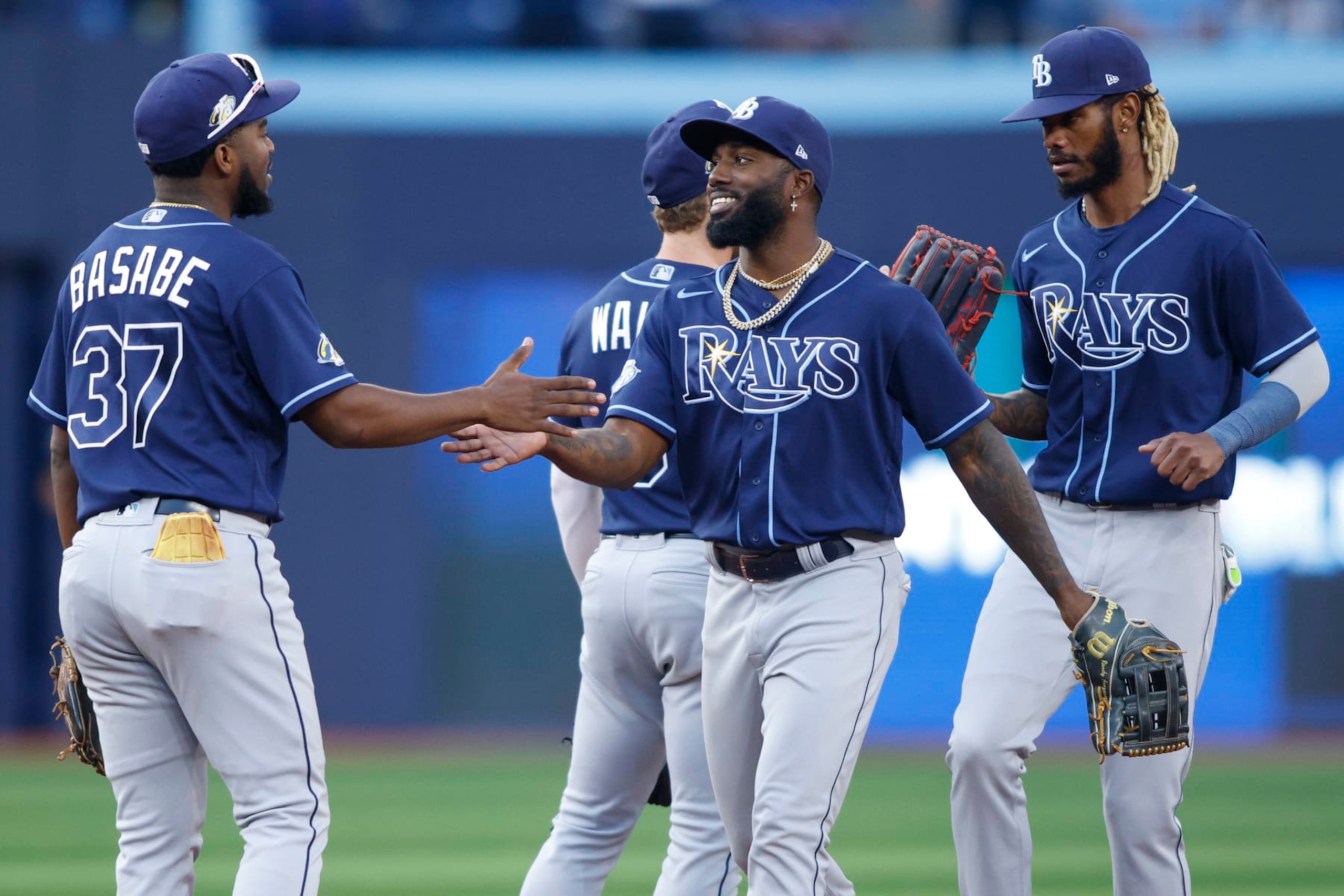 TORONTO, CANADA - SEPTEMBER 30: Osleivis Basabe #37 and Randy Arozarena #56 of the Tampa Bay Rays celebrate their MLB game victory over the Toronto Blue Jays at Rogers Centre on September 30, 2023 in Toronto, Canada. (Photo by Cole Burston/Getty Images)