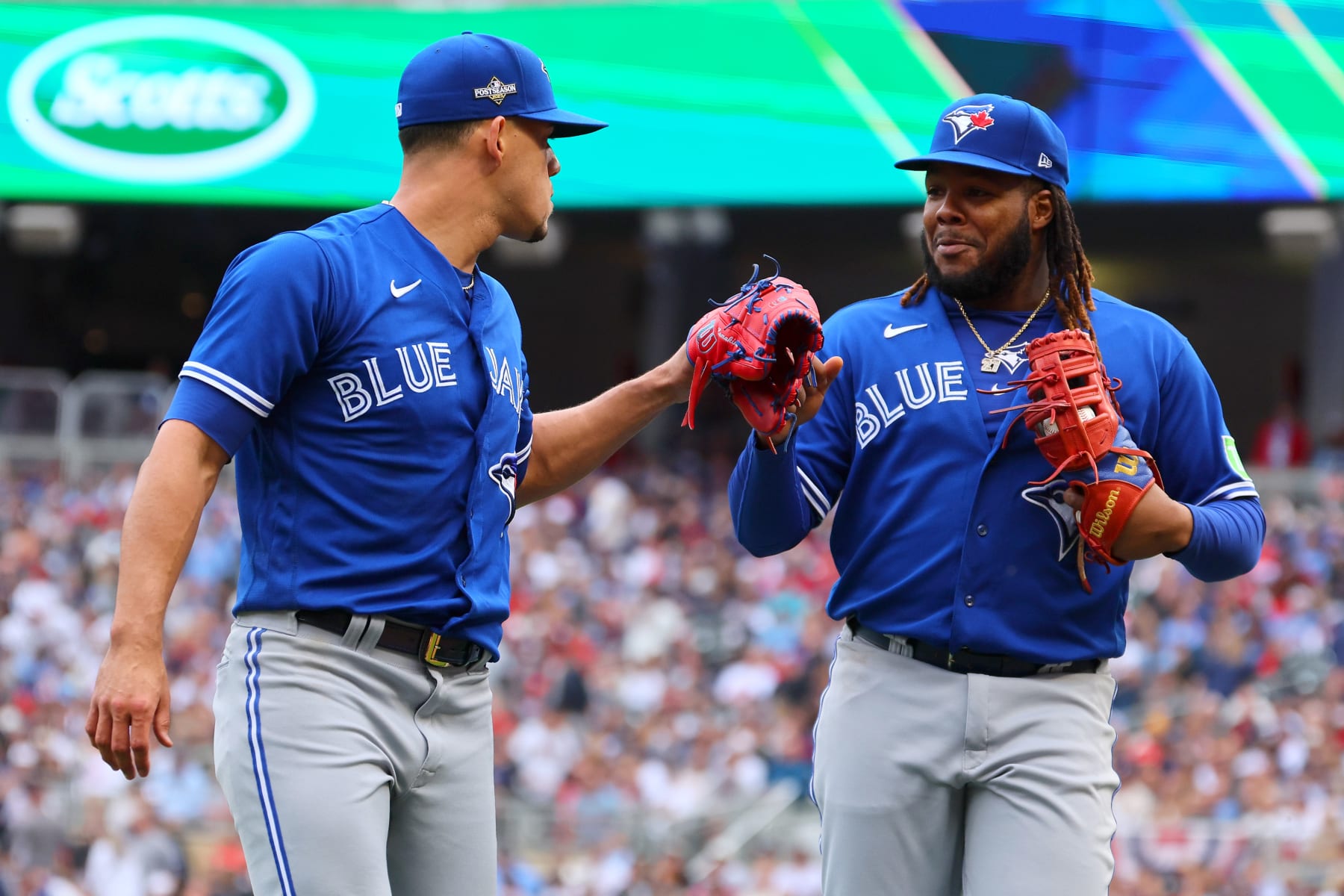 MINNEAPOLIS, MINNESOTA - OCTOBER 04: Jose Berrios #17 and Vladimir Guerrero Jr. #27 of the Toronto Blue Jays celebrate an out against the Minnesota Twins during the second inning in Game Two of the Wild Card Series at Target Field on October 04, 2023 in Minneapolis, Minnesota. (Photo by Adam Bettcher/Getty Images)