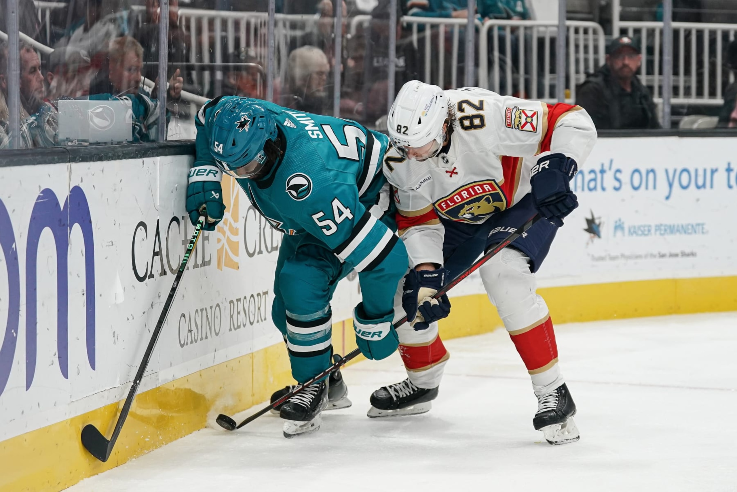 SAN JOSE, CA - NOVEMBER 14: Givani Smith #54 of the San Jose Sharks battles for the puck against Kevin Stenlund #82 of the Florida Panthers at SAP Center on November 14, 2023 in San Jose, California. (Photo by Kavin Mistry/NHLI via Getty Images) SAN JOSE, CA - NOVEMBER 14: Givani Smith #54 of the San Jose Sharks battles for the puck against Kevin Stenlund #82 of the Florida Panthers at SAP Center on November 14, 2023 in San Jose, California. (Photo by Kavin Mistry/NHLI via Getty Images)