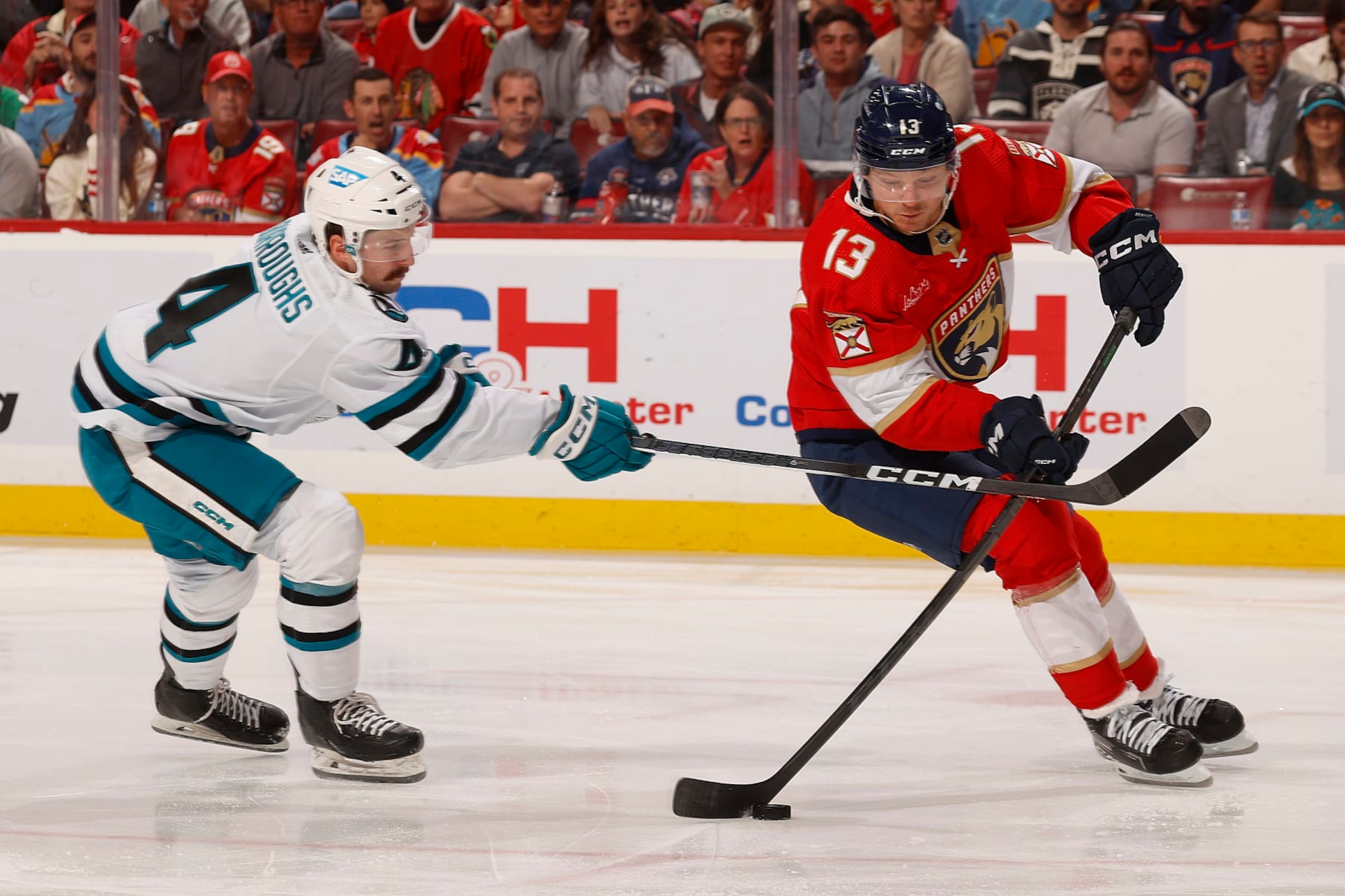 SUNRISE, FLORIDA - OCTOBER 24: Kyle Burroughs #4 of the San Jose Sharks crosses sticks with Sam Reinhart #13 of the Florida Panthers at the Amerant Bank Arena on October 24, 2023 in Sunrise, Florida. (Photo by Eliot J. Schechter/NHLI via Getty Images) SUNRISE, FLORIDA - OCTOBER 24: Kyle Burroughs #4 of the San Jose Sharks crosses sticks with Sam Reinhart #13 of the Florida Panthers at the Amerant Bank Arena on October 24, 2023 in Sunrise, Florida. (Photo by Eliot J. Schechter/NHLI via Getty Images)