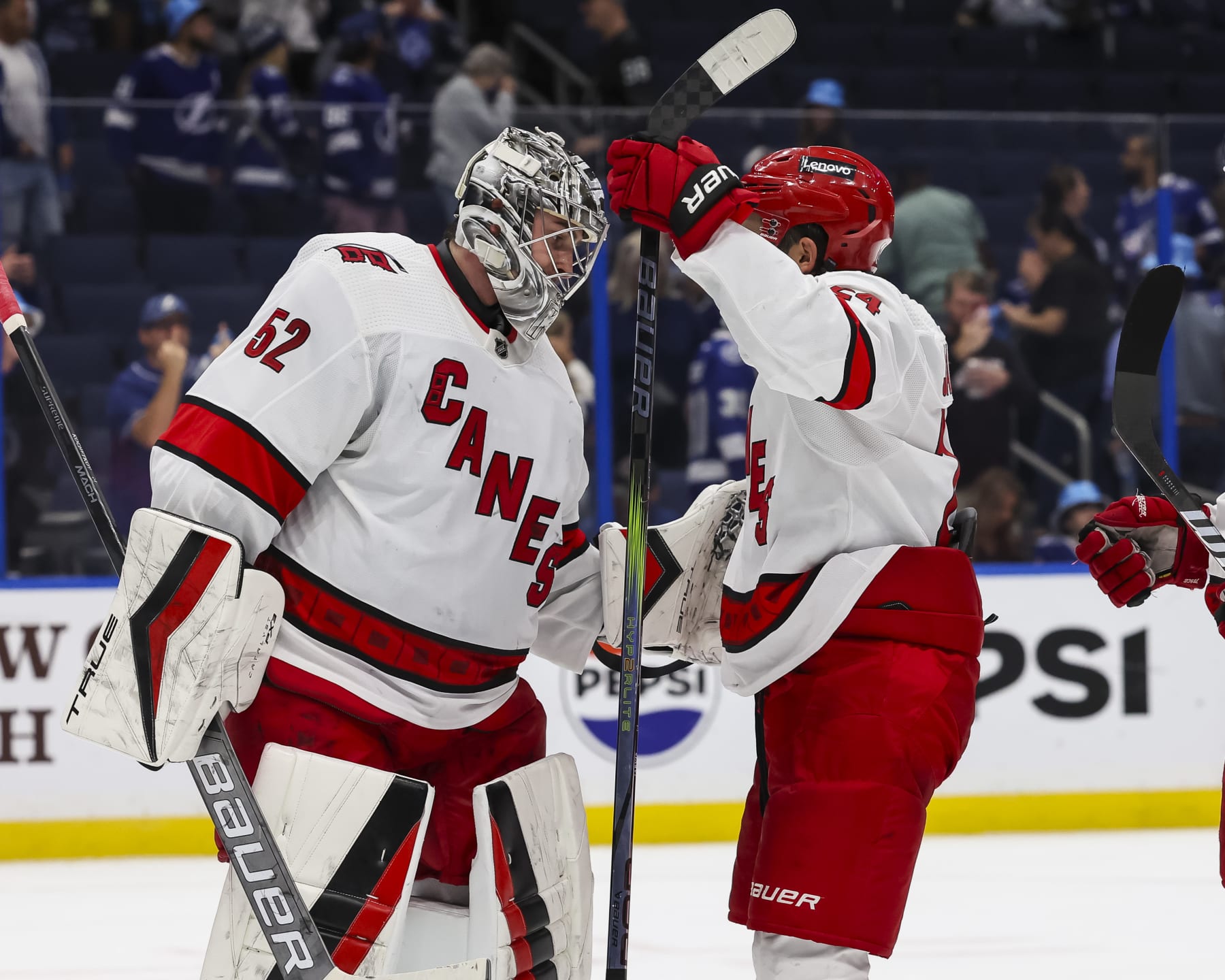 TAMPA, FL - NOVEMBER 11: Goalie Pyotr Kochetkov #52 and Seth Jarvis #24 of the Carolina Hurricanes celebrate the win against the Tampa Bay Lightning at Amalie Arena on November 11, 2023 in Tampa, Florida. (Photo by Mark LoMoglio/NHLI via Getty Images)