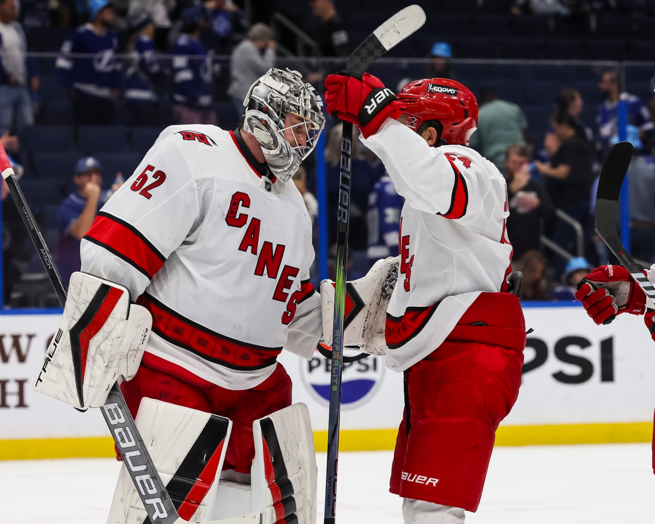 TAMPA, FL - NOVEMBER 11: Goalie Pyotr Kochetkov #52 and Seth Jarvis #24 of the Carolina Hurricanes celebrate the win against the Tampa Bay Lightning at Amalie Arena on November 11, 2023 in Tampa, Florida. (Photo by Mark LoMoglio/NHLI via Getty Images) TAMPA, FL - NOVEMBER 11: Goalie Pyotr Kochetkov #52 and Seth Jarvis #24 of the Carolina Hurricanes celebrate the win against the Tampa Bay Lightning at Amalie Arena on November 11, 2023 in Tampa, Florida. (Photo by Mark LoMoglio/NHLI via Getty Images)