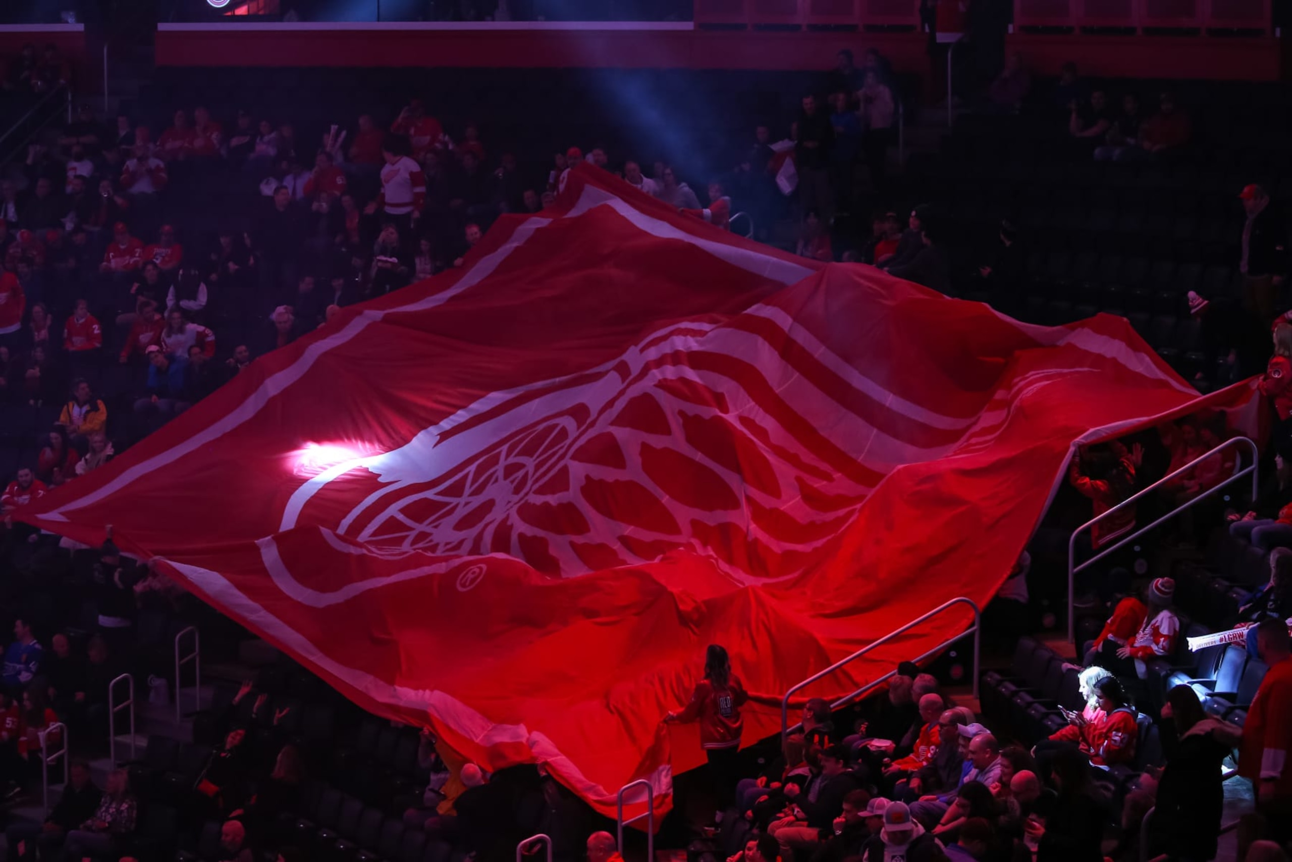 DETROIT, MI - MARCH 22:  Fans hold a large Red Wings logo banner prior to the start of a regular season NHL hockey game between the Philadelphia Flyers and the Detroit Red Wings on March 22, 2022 at Little Caesars Arena in Detroit, Michigan.  (Photo by Scott W. Grau/Icon Sportswire via Getty Images)