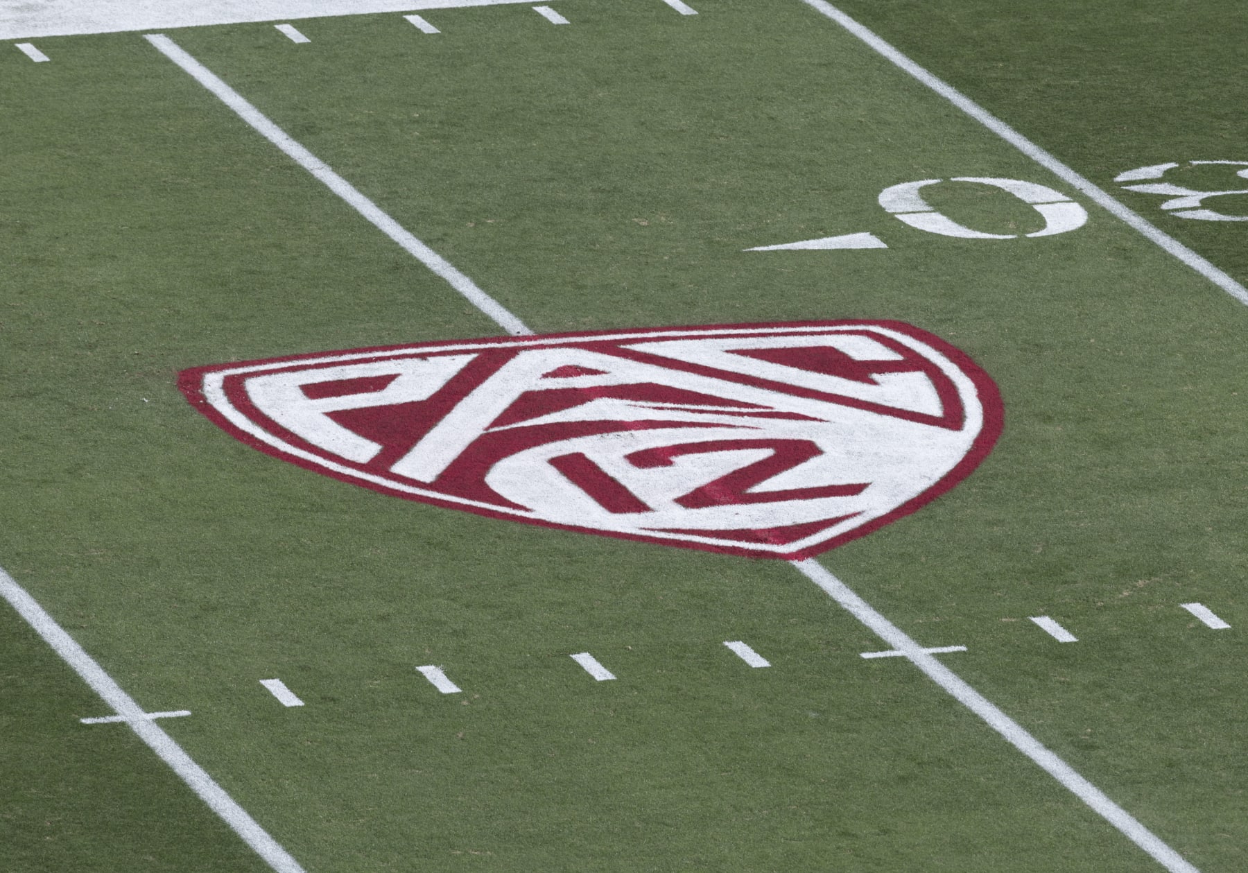 PALO ALTO, CA - OCTOBER 28: A detail view of the Pac-12 logo on the field at Stanford Stadium before a Pac-12 NCAA college football game between the Stanford Cardinal and the Washington Huskies on October 28, 2023 at Stanford Stadium in Palo Alto, California. (Photo by David Madison/Getty Images) PALO ALTO, CA - OCTOBER 28: A detail view of the Pac-12 logo on the field at Stanford Stadium before a Pac-12 NCAA college football game between the Stanford Cardinal and the Washington Huskies on October 28, 2023 at Stanford Stadium in Palo Alto, California. (Photo by David Madison/Getty Images)