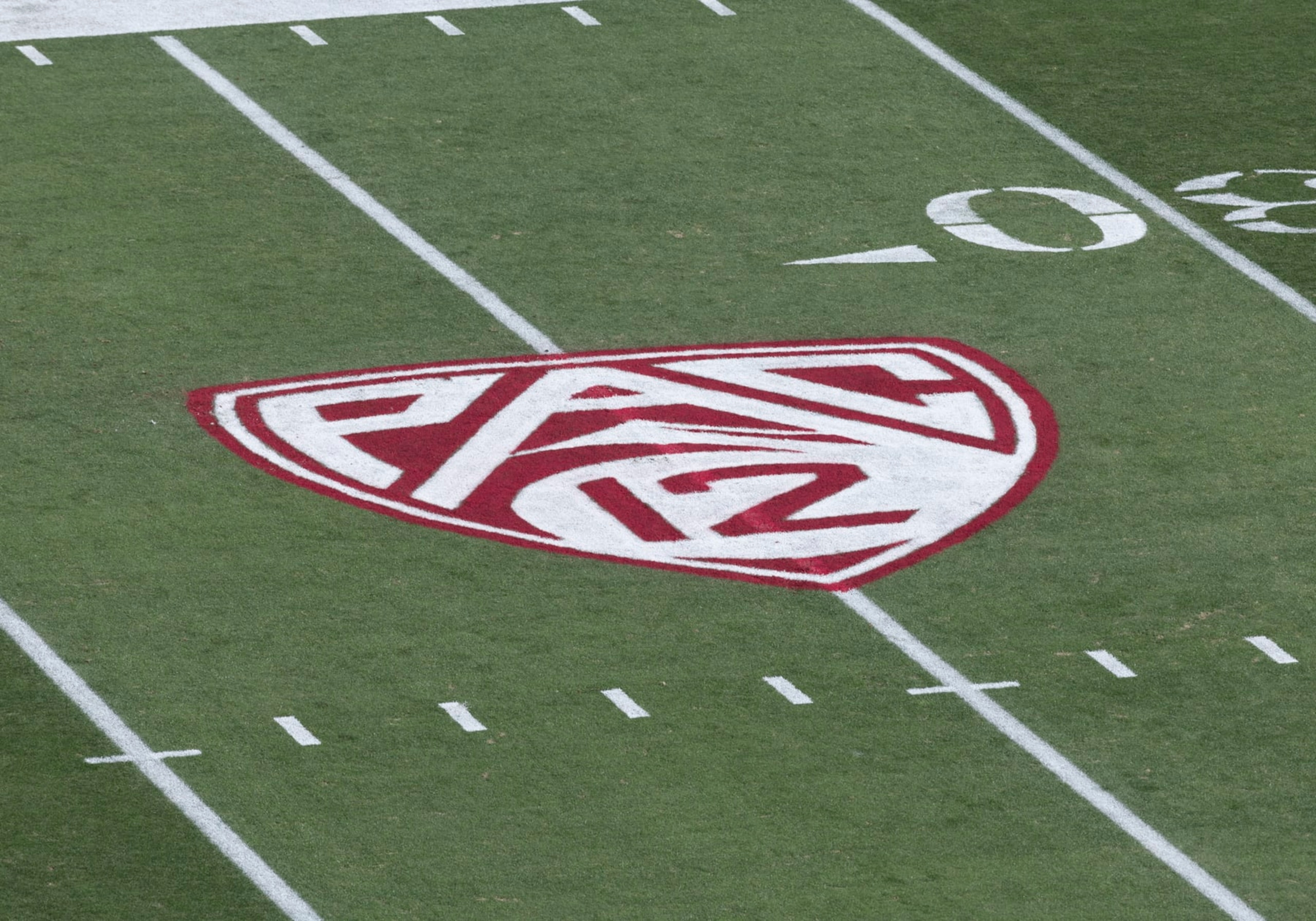 PALO ALTO, CA - OCTOBER 28: A detail view of the Pac-12 logo on the field at Stanford Stadium before a Pac-12 NCAA college football game between the Stanford Cardinal and the Washington Huskies on October 28, 2023 at Stanford Stadium in Palo Alto, California. (Photo by David Madison/Getty Images) PALO ALTO, CA - OCTOBER 28: A detail view of the Pac-12 logo on the field at Stanford Stadium before a Pac-12 NCAA college football game between the Stanford Cardinal and the Washington Huskies on October 28, 2023 at Stanford Stadium in Palo Alto, California. (Photo by David Madison/Getty Images)
