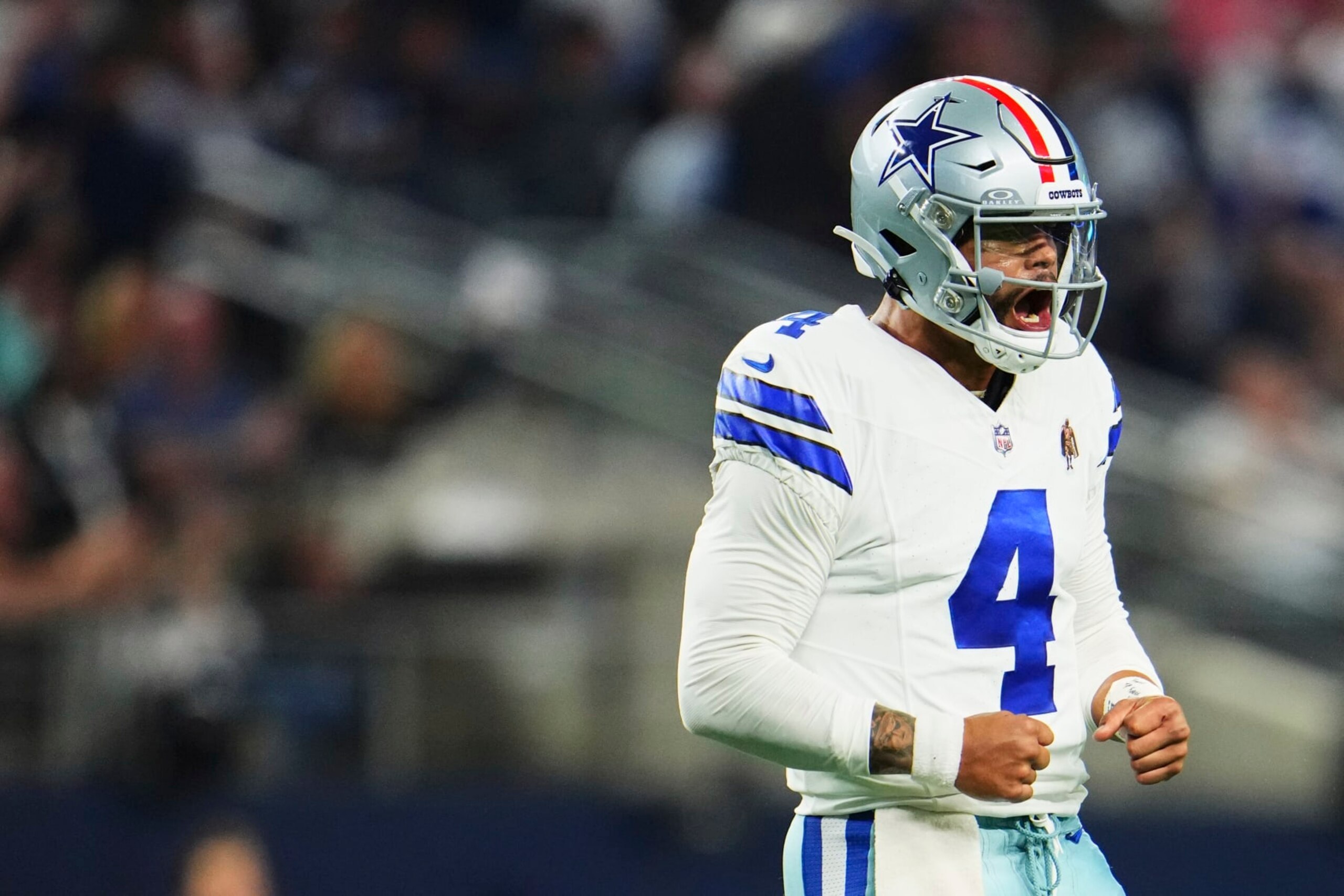ARLINGTON, TX - NOVEMBER 12: Dak Prescott #4 of the Dallas Cowboys celebrates after scoring a touchdown against the New York Giants during the second half at AT&T Stadium on November 12, 2023 in Arlington, Texas. (Photo by Cooper Neill/Getty Images)