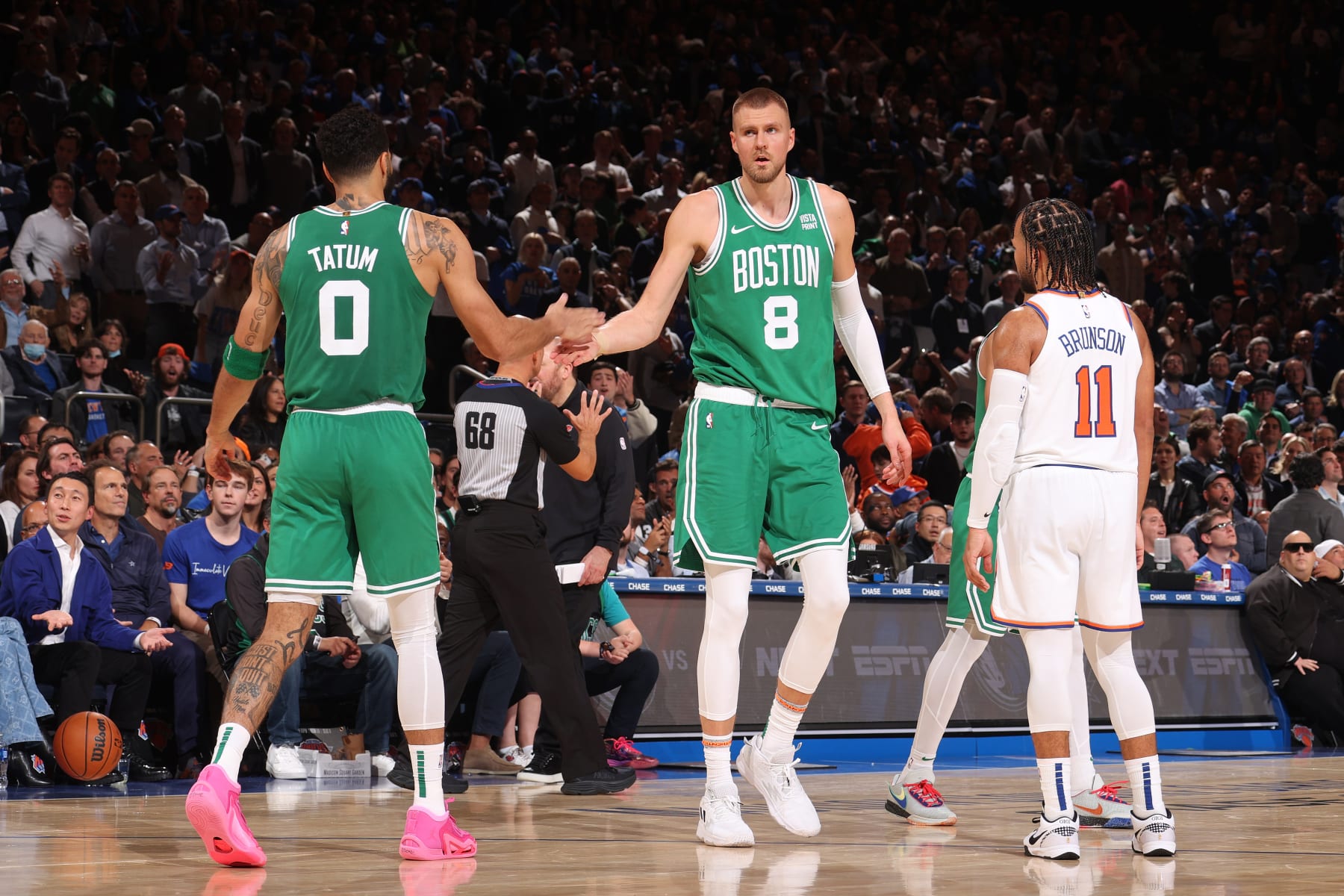 NEW YORK, NY - OCTOBER 25: Jayson Tatum #0 and Kristaps Porzingis #8 of the Boston Celtics high five during the game against the New York Knicks on October 25, 2023 at Madison Square Garden in New York City, New York.  NOTE TO USER: User expressly acknowledges and agrees that, by downloading and or using this photograph, User is consenting to the terms and conditions of the Getty Images License Agreement. Mandatory Copyright Notice: Copyright 2023 NBAE  (Photo by Nathaniel S. Butler/NBAE via Getty Images)