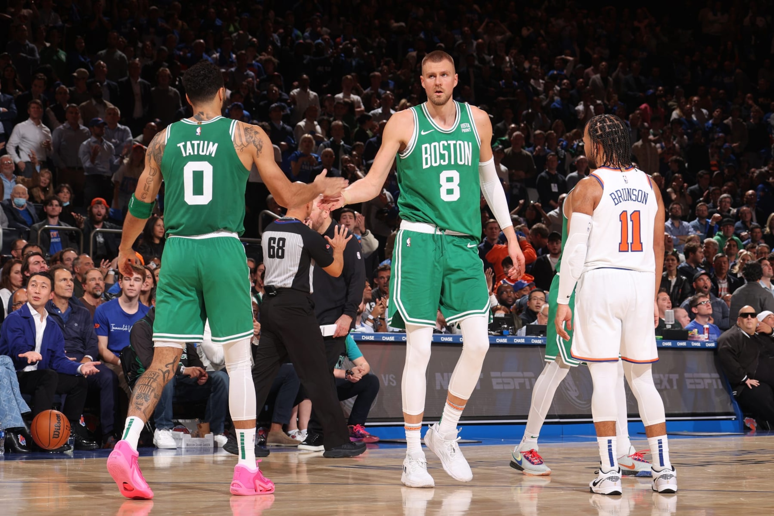 NEW YORK, NY - OCTOBER 25: Jayson Tatum #0 and Kristaps Porzingis #8 of the Boston Celtics high five during the game against the New York Knicks on October 25, 2023 at Madison Square Garden in New York City, New York.  NOTE TO USER: User expressly acknowledges and agrees that, by downloading and or using this photograph, User is consenting to the terms and conditions of the Getty Images License Agreement. Mandatory Copyright Notice: Copyright 2023 NBAE  (Photo by Nathaniel S. Butler/NBAE via Getty Images)