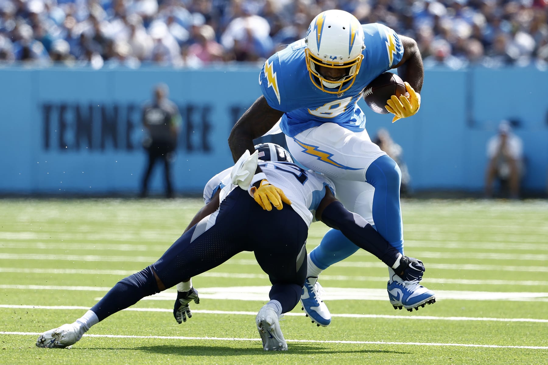 NASHVILLE, TENNESSEE - SEPTEMBER 17: Tre Avery #23 of the Tennessee Titans tackles Mike Williams #81 of the Los Angeles Chargers during the first quarter at Nissan Stadium on September 17, 2023 in Nashville, Tennessee. (Photo by Johnnie Izquierdo/Getty Images)