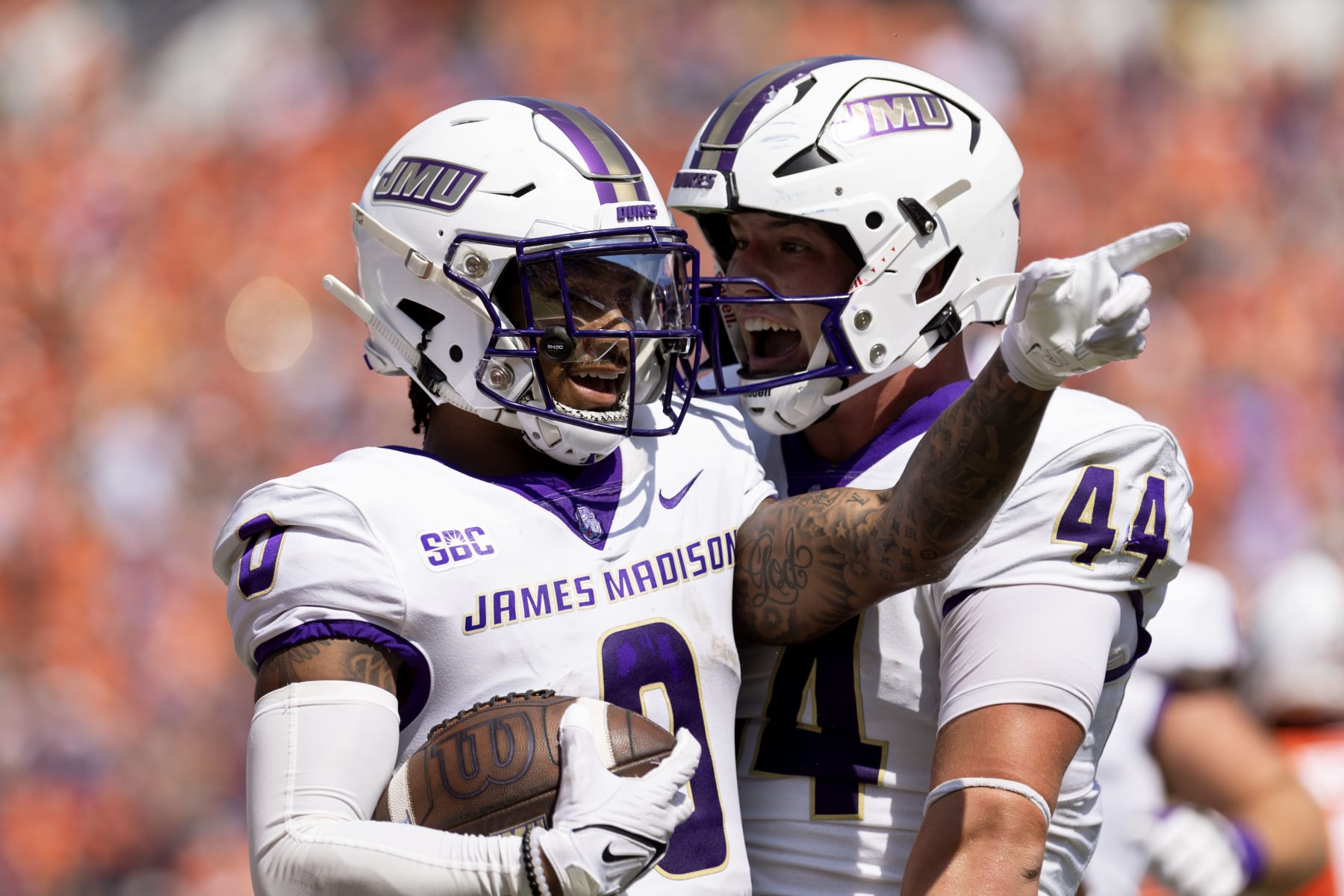 CHARLOTTESVILLE, VIRGINIA - SEPTEMBER 9: Phoenix Sproles #0 and Zach Horton #44 of the James Madison Dukes celebrate a touchdown in the first half during a game against the Virginia Cavaliers at Scott Stadium on September 9, 2023 in Charlottesville, Virginia. (Photo by Ryan M. Kelly/Getty Images)