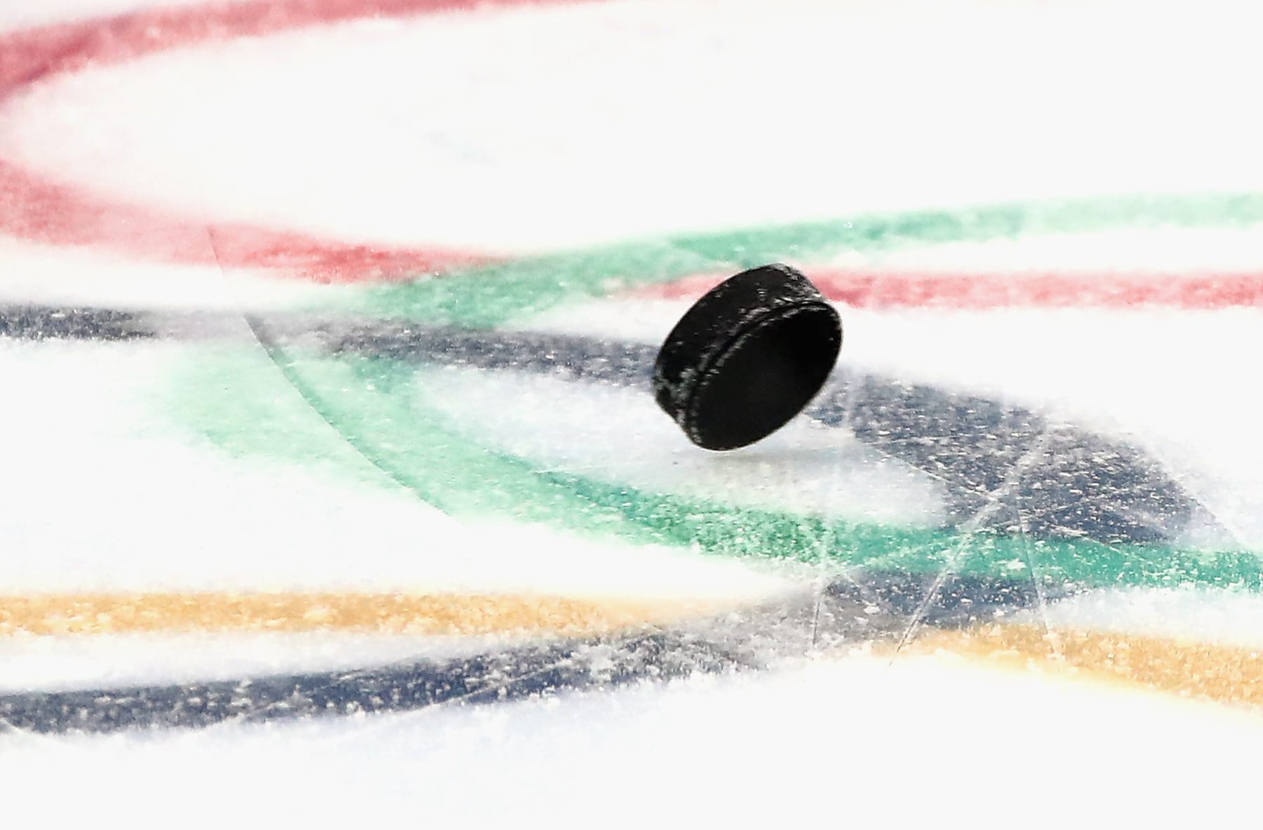 PYEONGCHANG-GUN, SOUTH KOREA - FEBRUARY 09:  A puck bounces over the Olympic logo embedded in the ice during the Men's USA Ice Hockey Team practice ahead of the PyeongChang 2018 Winter Olympic Games at the Gangneung Hockey Centre on February 9, 2018 in Pyeongchang-gun, South Korea.  (Photo by Bruce Bennett/Getty Images)
