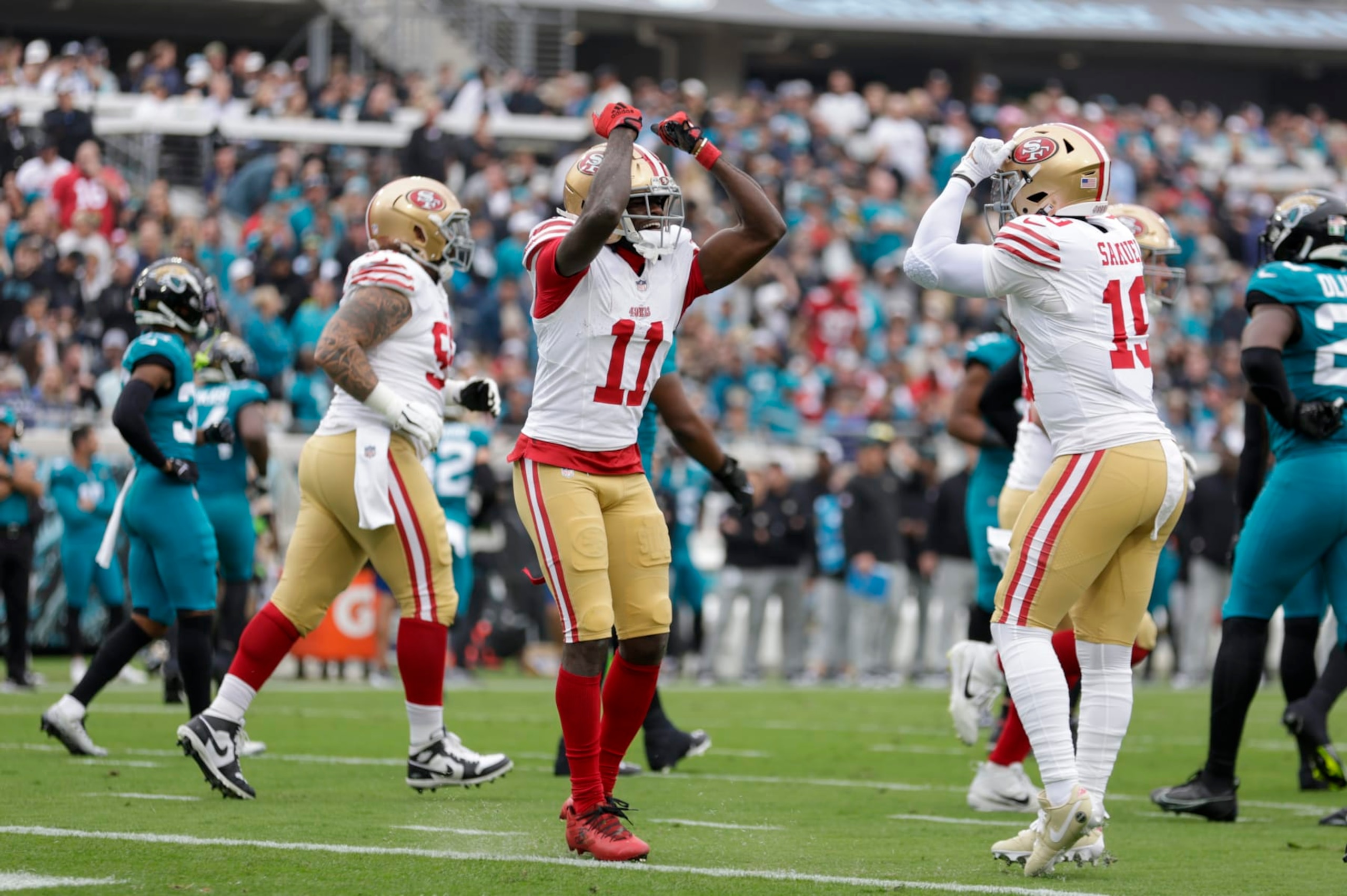 JACKSONVILLE, FL - NOVEMBER 12: San Francisco 49ers wide receiver Brandon Aiyuk (11) and San Francisco 49ers wide receiver Deebo Samuel (19) celebrate a touchdown during the game between the San Francisco 49ers and theJacksonville Jaguars on November 12, 2023 at  EverBank Stadium in Jacksonville, Florida. (Photo by David Rosenblum/Icon Sportswire via Getty Images)