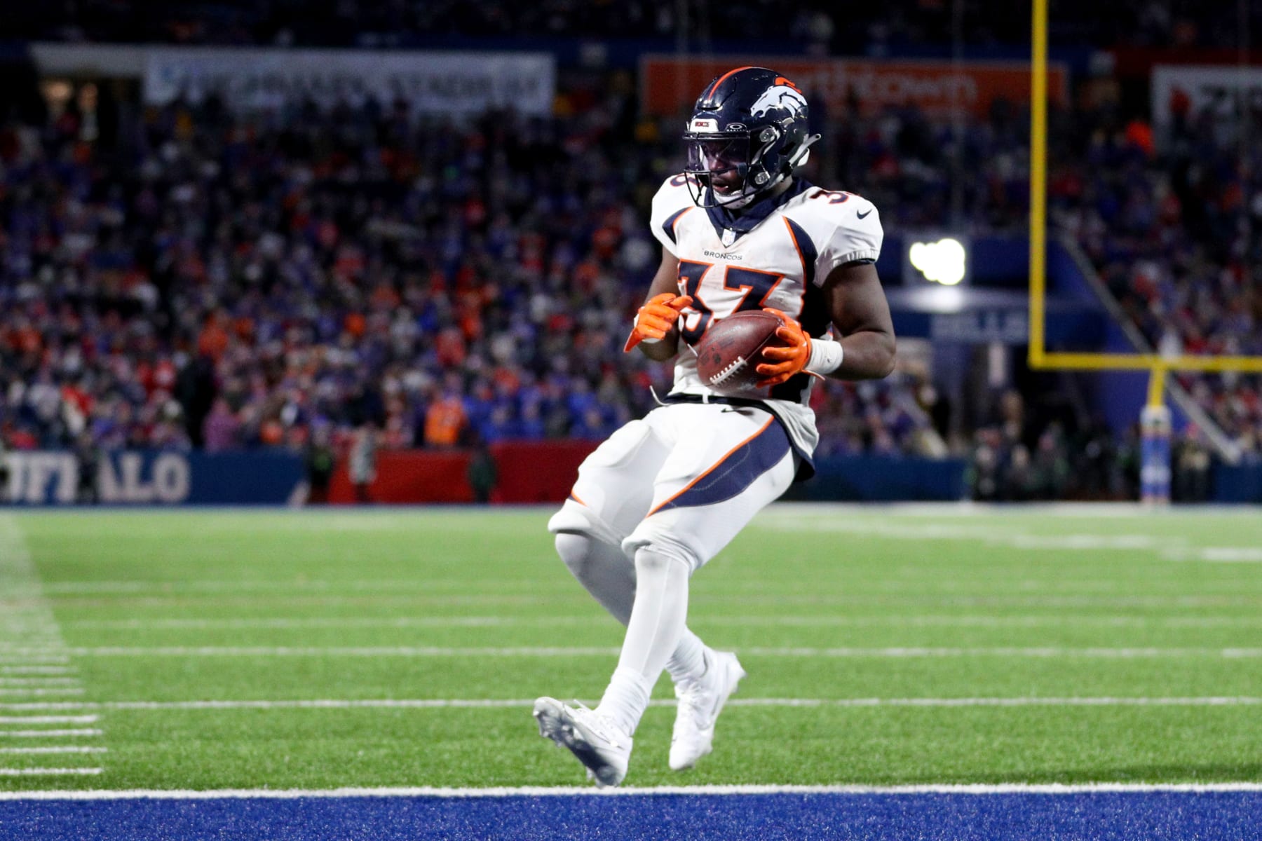 ORCHARD PARK, NEW YORK - NOVEMBER 13: Javonte Williams #33 of the Denver Broncos carries the ball for a touchdown against the Buffalo Bills during the fourth quarter at Highmark Stadium on November 13, 2023 in Orchard Park, New York. (Photo by Bryan M. Bennett/Getty Images)