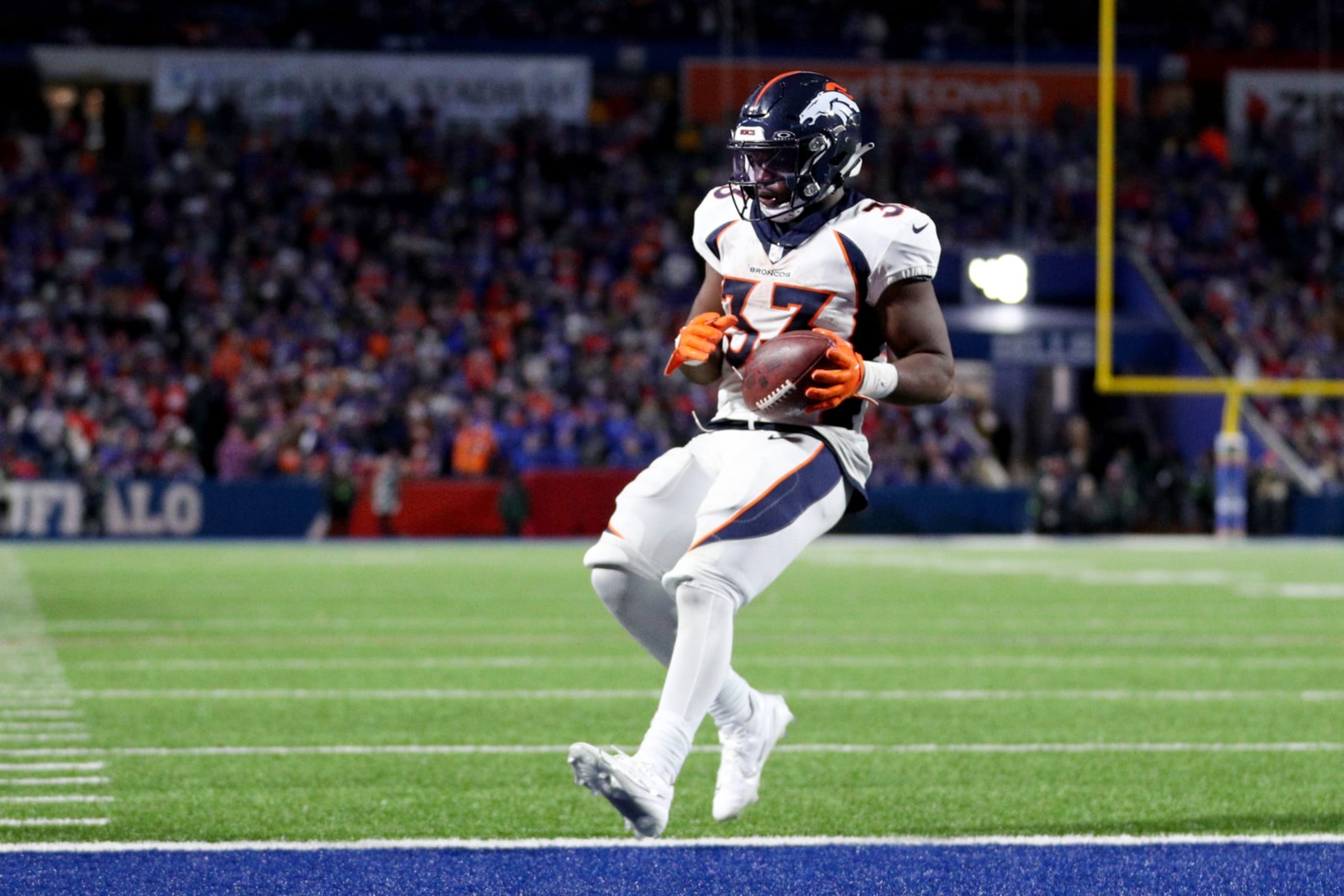 ORCHARD PARK, NEW YORK - NOVEMBER 13: Javonte Williams #33 of the Denver Broncos carries the ball for a touchdown against the Buffalo Bills during the fourth quarter at Highmark Stadium on November 13, 2023 in Orchard Park, New York. (Photo by Bryan M. Bennett/Getty Images)