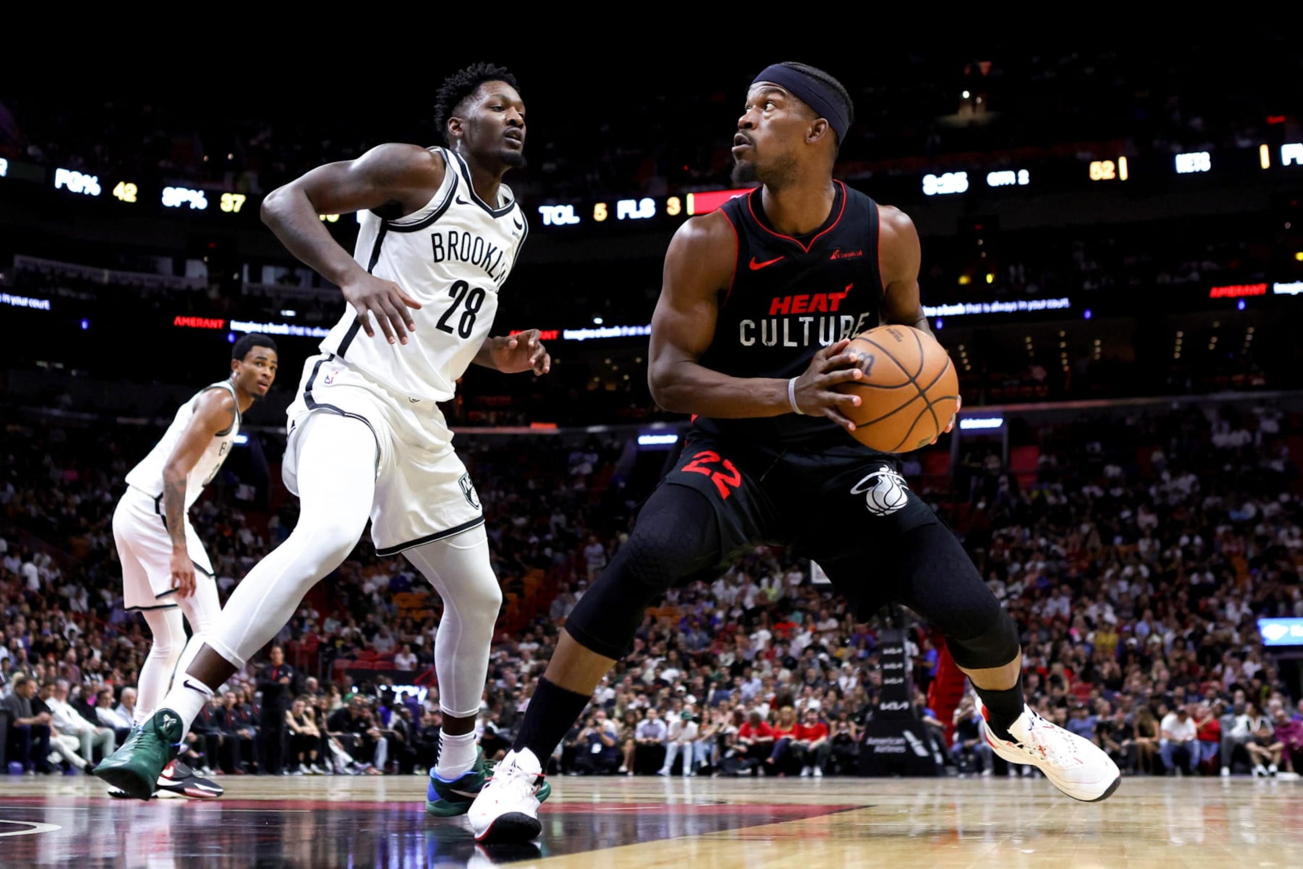 MIAMI, FLORIDA - NOVEMBER 16: Jimmy Butler #22 of the Miami Heat drives against Dorian Finney-Smith #28 of the Brooklyn Nets during the second quarter of the game at Kaseya Center on November 16, 2023 in Miami, Florida. NOTE TO USER: User expressly acknowledges and agrees that, by downloading and or using this photograph, User is consenting to the terms and conditions of the Getty Images License Agreement. (Photo by Megan Briggs/Getty Images)