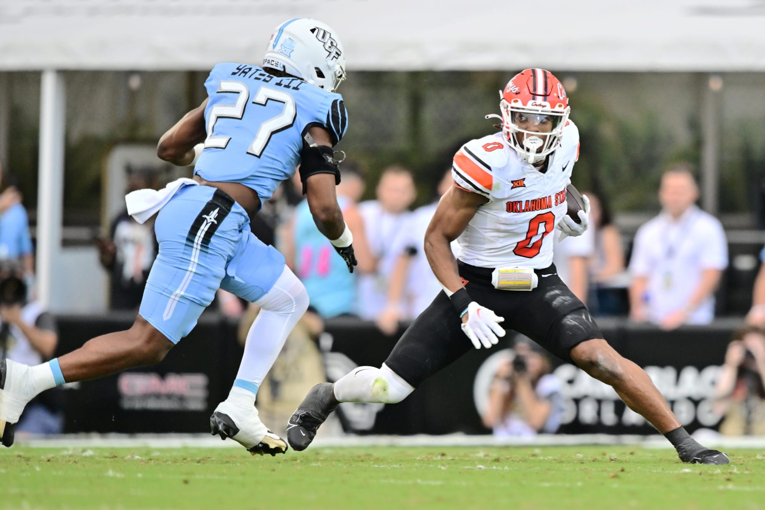 ORLANDO, FLORIDA - NOVEMBER 11: Ollie Gordon II #0 of the Oklahoma State Cowboys runs the ball against Walter Yates III #27 of the UCF Knights in the first half of a game at FBC Mortgage Stadium on November 11, 2023 in Orlando, Florida. (Photo by Julio Aguilar/Getty Images) ORLANDO, FLORIDA - NOVEMBER 11: Ollie Gordon II #0 of the Oklahoma State Cowboys runs the ball against Walter Yates III #27 of the UCF Knights in the first half of a game at FBC Mortgage Stadium on November 11, 2023 in Orlando, Florida. (Photo by Julio Aguilar/Getty Images)