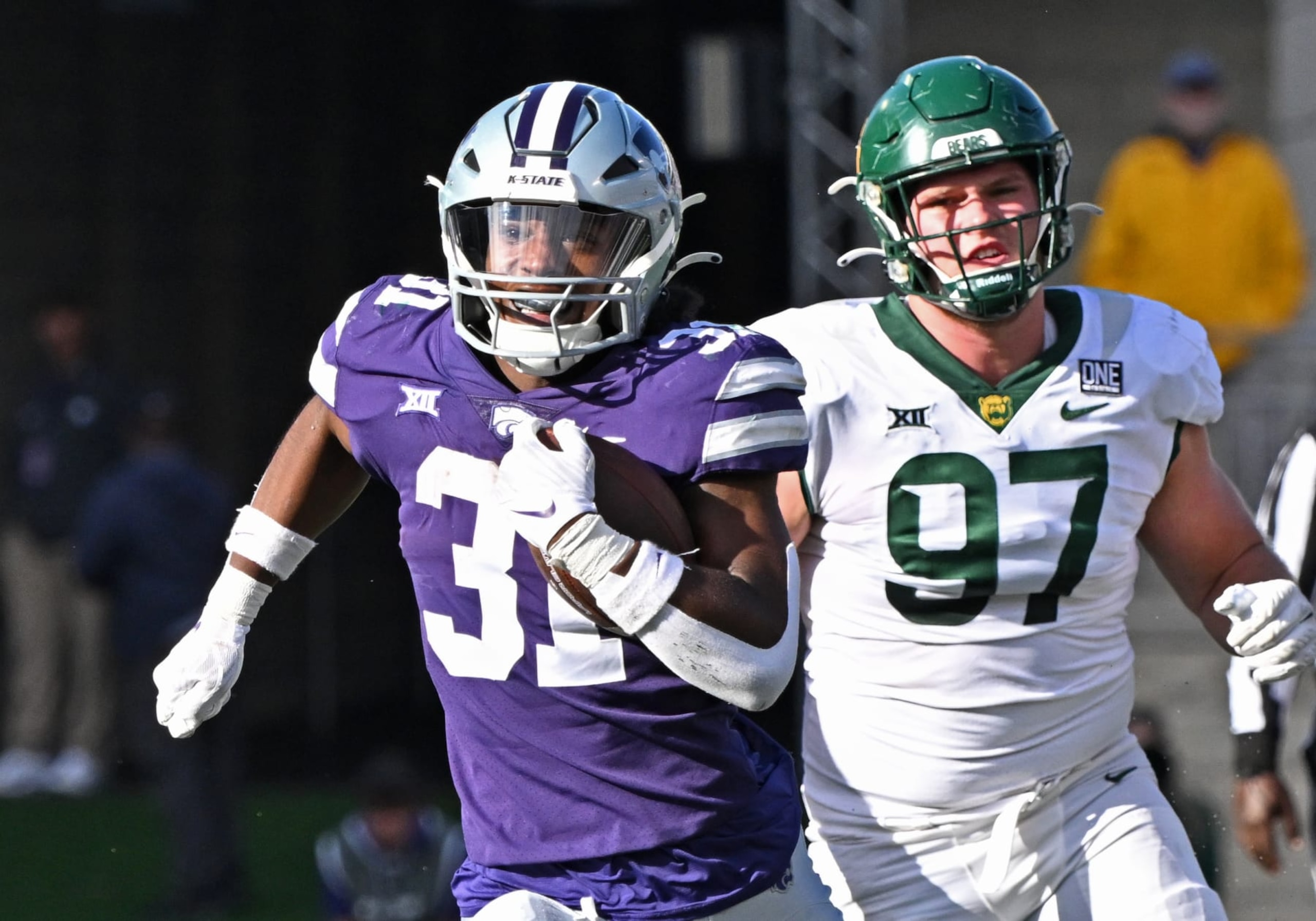 MANHATTAN, KS - NOVEMBER 11: Running back DJ Giddens #31 of the Kansas State Wildcats runs down field with the ball past defensive lineman Cooper Lanz #97 of the Baylor Bears in the first half at Bill Snyder Family Football Stadium on November 11, 2023 in Manhattan, Kansas. (Photo by Peter G. Aiken/Getty Images) MANHATTAN, KS - NOVEMBER 11: Running back DJ Giddens #31 of the Kansas State Wildcats runs down field with the ball past defensive lineman Cooper Lanz #97 of the Baylor Bears in the first half at Bill Snyder Family Football Stadium on November 11, 2023 in Manhattan, Kansas. (Photo by Peter G. Aiken/Getty Images)