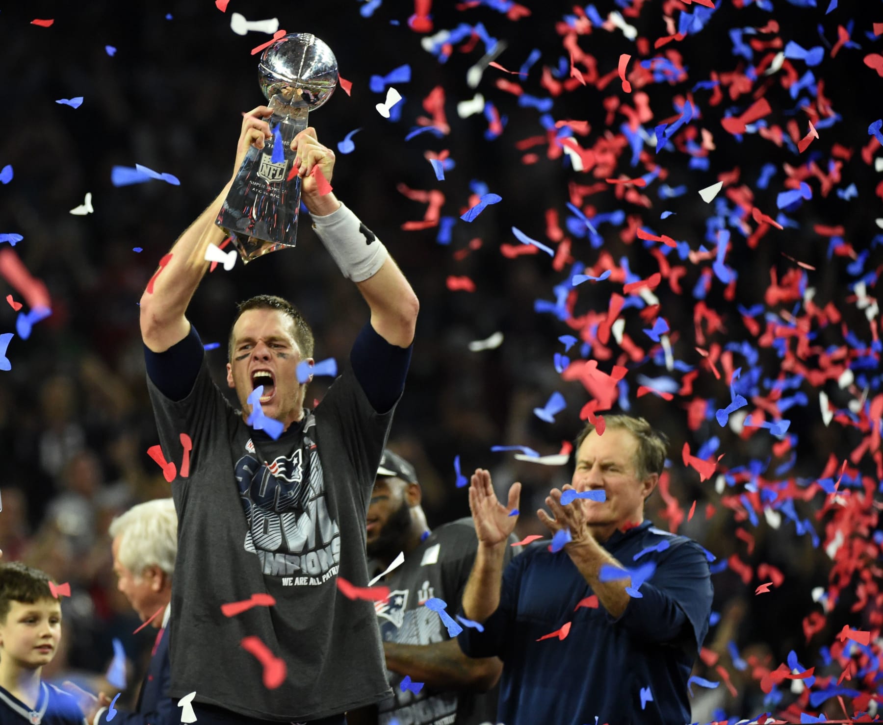 Tom Brady #12 of the New England Patriots holds the Vince Lombardi Trophy as Head coach Bill Belichick (R) looks on  after defeating the Atlanta Falcons 34-28 in overtime during Super Bowl 51 at NRG Stadium on February 5, 2017 in Houston, Texas.
The Patriots defeated the Falcons 34-28 after overtime.  / AFP / Timothy A. CLARY        (Photo credit should read TIMOTHY A. CLARY/AFP via Getty Images)