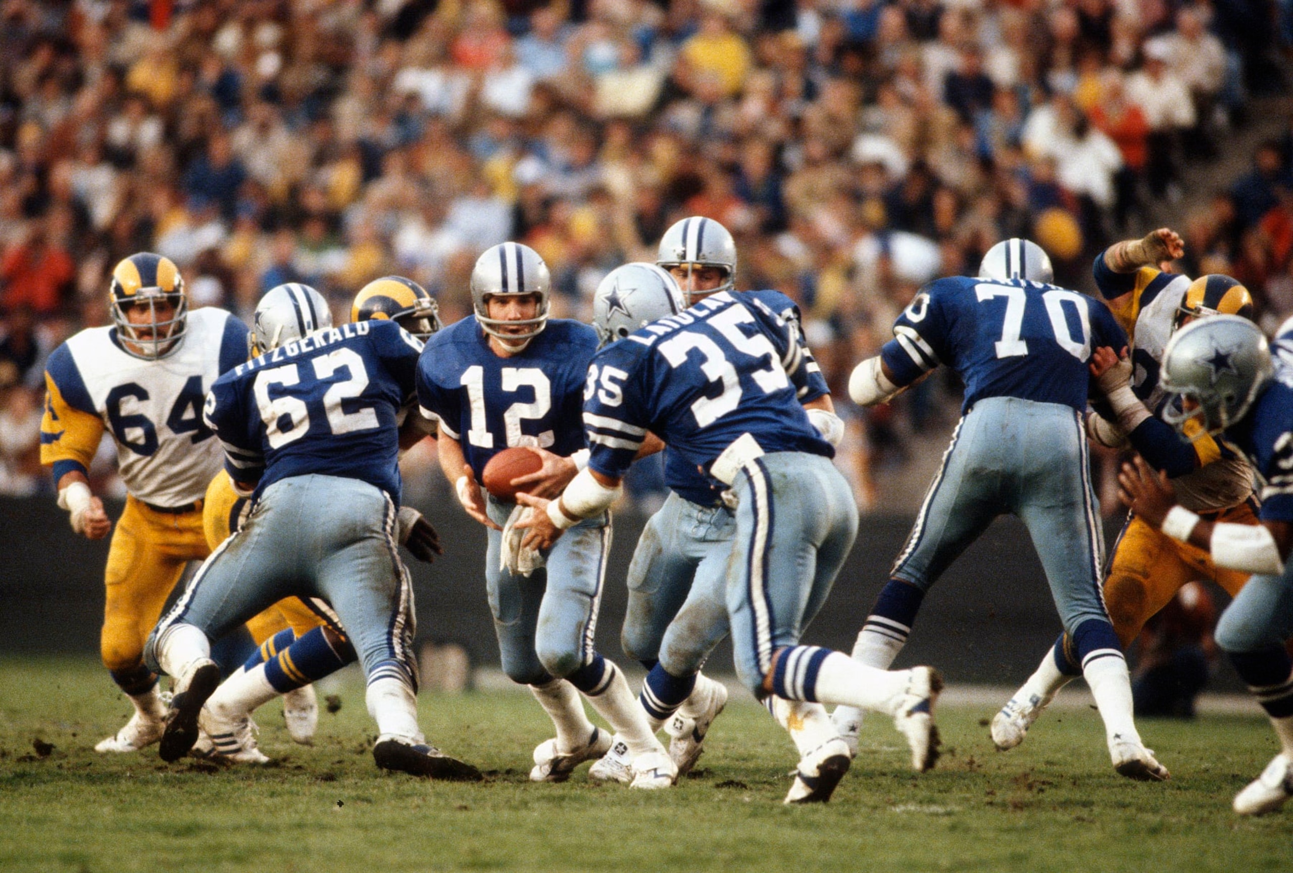 LOS ANGELES, CA - JANUARY 4:  Roger Staubach #12 of Dallas Cowboys in action against the Los Angeles Rams circa mid 1970's during the NFC Conference Championship game January 4, 1976 at the Los Angeles Memorial Coliseum in Los Angeles, California. Staubach played for the Cowboys from 1969-79. (Photo by Focus on Sport/Getty Images) 