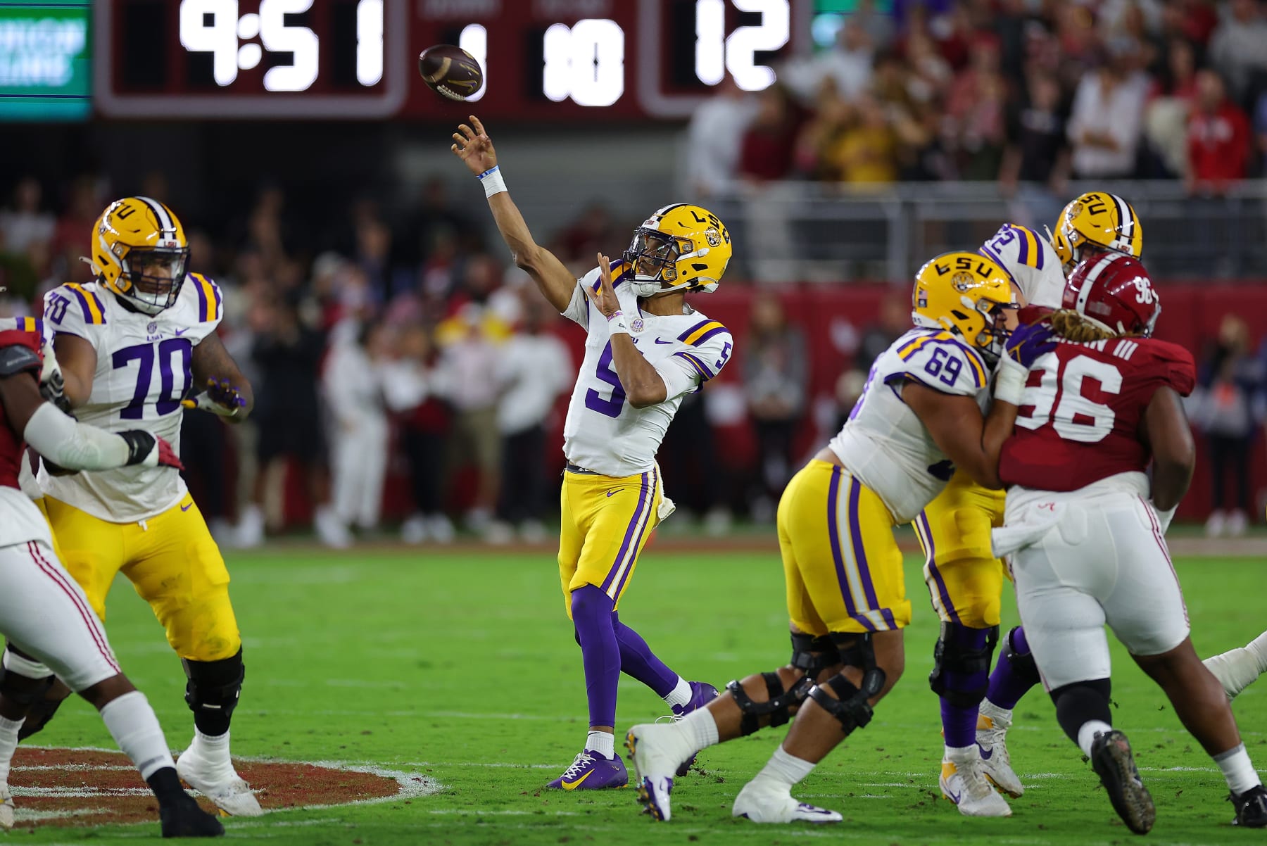 TUSCALOOSA, ALABAMA - NOVEMBER 04:  Jayden Daniels #5 of the LSU Tigers passes for a touchdown against the Alabama Crimson Tide during the first quarter at Bryant-Denny Stadium on November 04, 2023 in Tuscaloosa, Alabama.  (Photo by Kevin C. Cox/Getty Images)