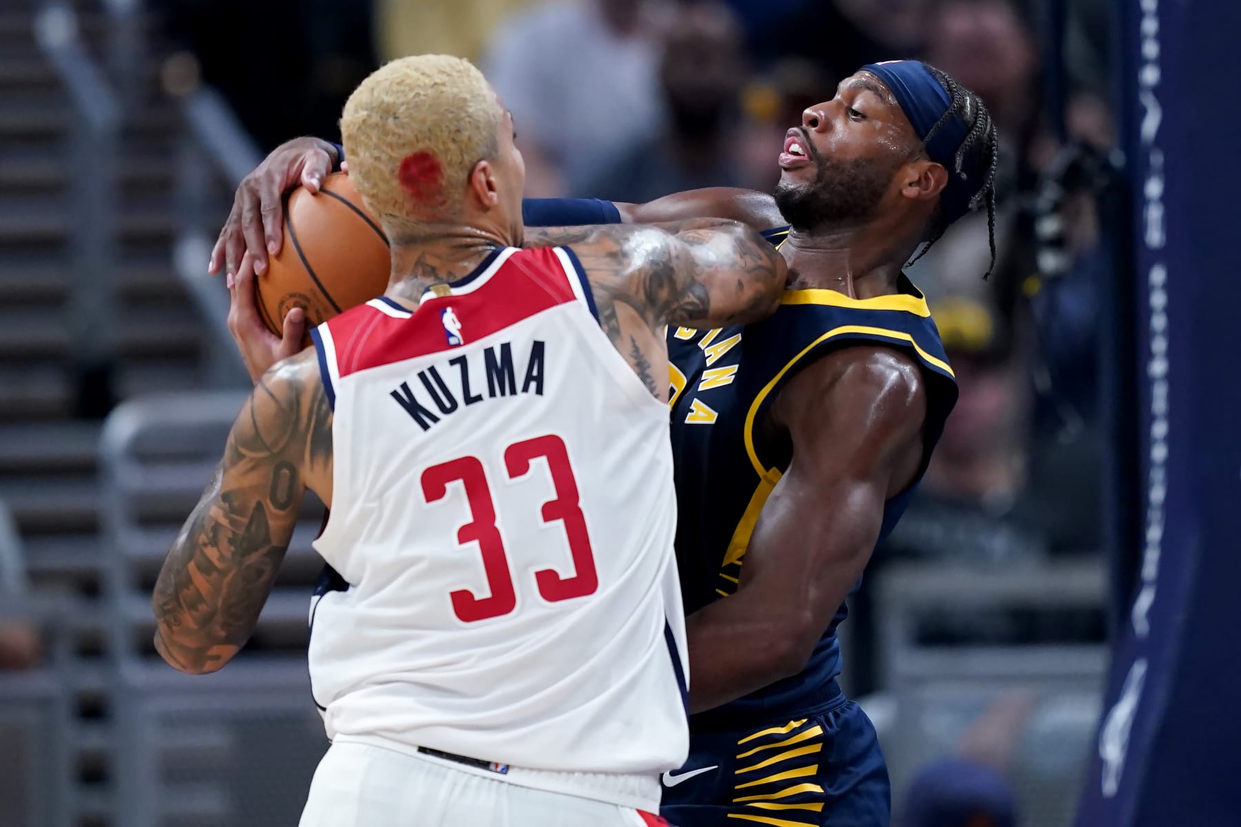 INDIANAPOLIS, INDIANA - OCTOBER 25: Kyle Kuzma #33 of the Washington Wizards is guarded by Buddy Hield #7 of the Indiana Pacers in the first quarter at Gainbridge Fieldhouse on October 25, 2023 in Indianapolis, Indiana. NOTE TO USER: User expressly acknowledges and agrees that, by downloading and or using this photograph, User is consenting to the terms and conditions of the Getty Images License Agreement. (Photo by Dylan Buell/Getty Images)