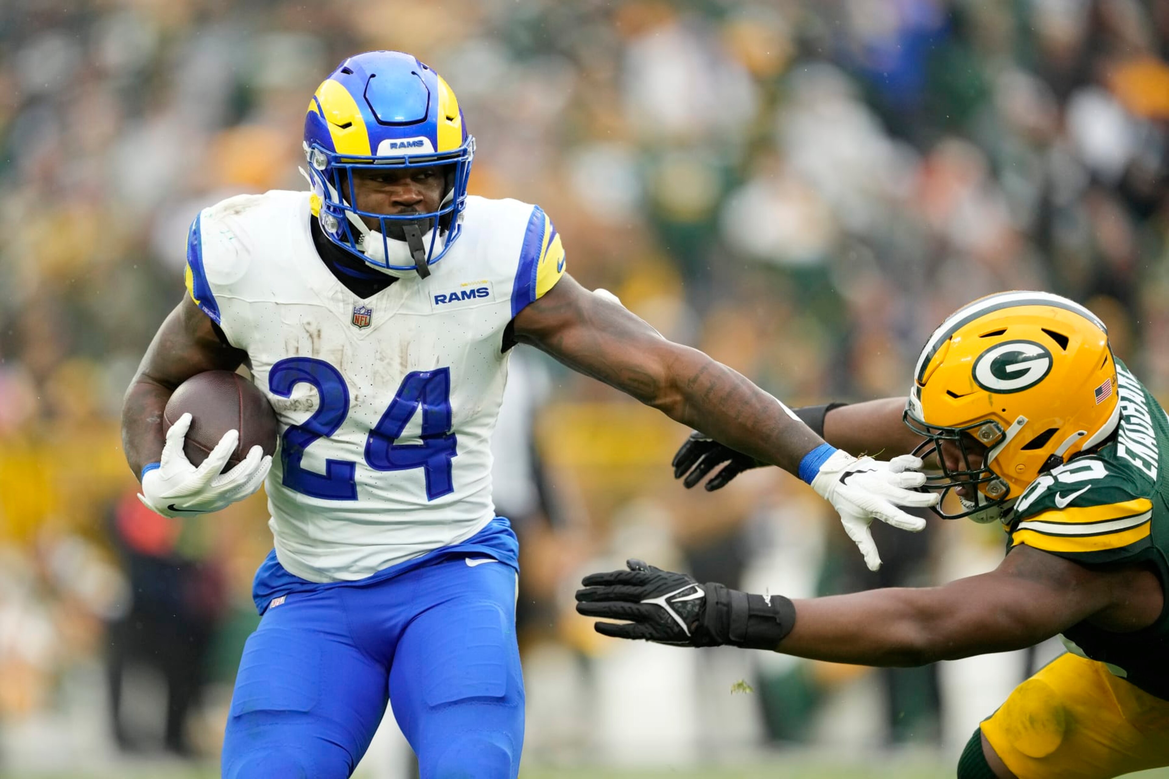 GREEN BAY, WISCONSIN - NOVEMBER 05: Royce Freeman #24 of the Los Angeles Rams avoids the tackle of Kingsley Enagbare #55 of the Green Bay Packers in the second half at Lambeau Field on November 05, 2023 in Green Bay, Wisconsin. (Photo by Patrick McDermott/Getty Images)