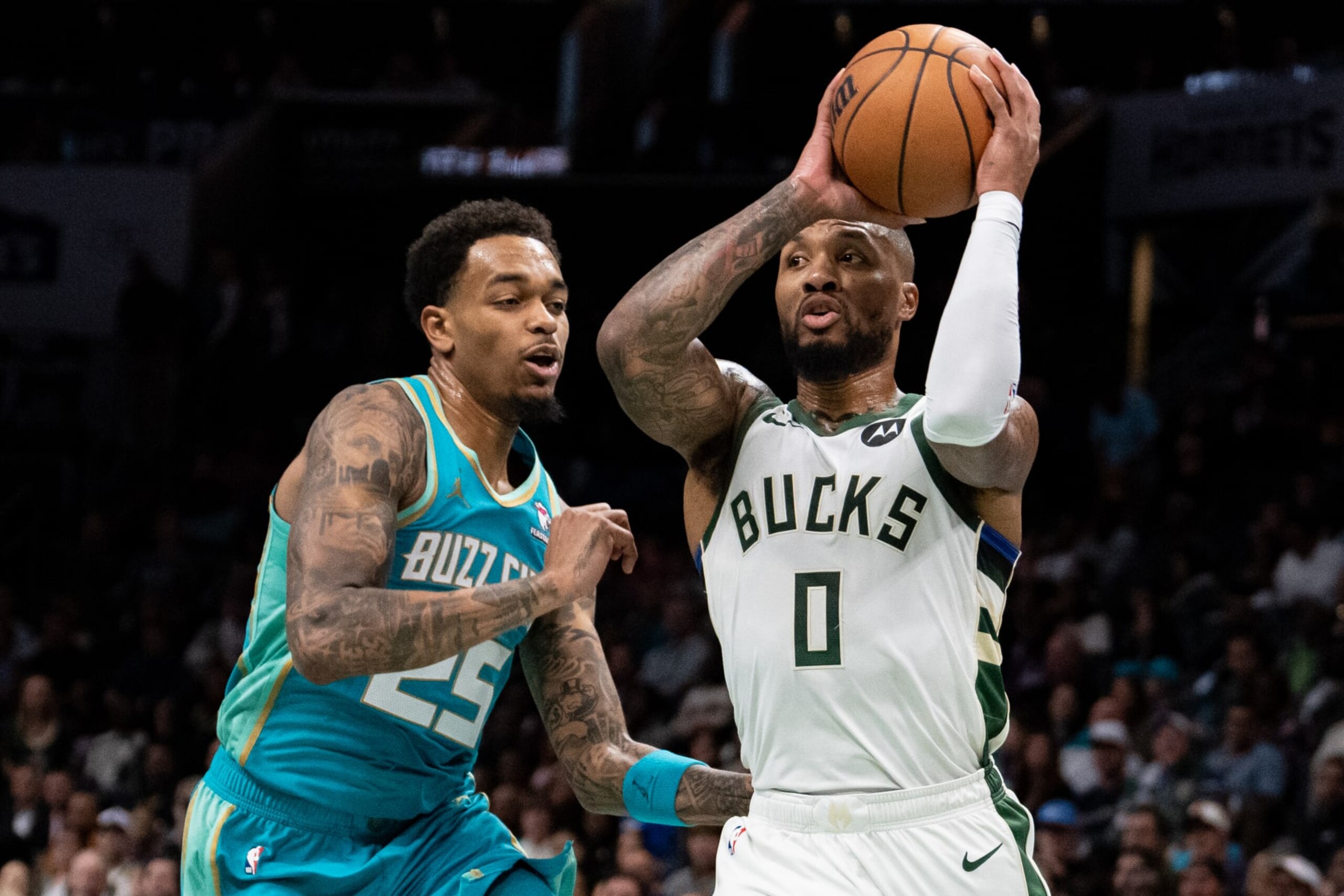 CHARLOTTE, NORTH CAROLINA - NOVEMBER 17: Damian Lillard #0 of the Milwaukee Bucks drives to the basket while guarded by P.J. Washington #25 of the Charlotte Hornets in the first quarter during an NBA In-Season Tournament game at Spectrum Center on November 17, 2023 in Charlotte, North Carolina. NOTE TO USER: User expressly acknowledges and agrees that, by downloading and or using this photograph, User is consenting to the terms and conditions of the Getty Images License Agreement. (Photo by Jacob Kupferman/Getty Images)