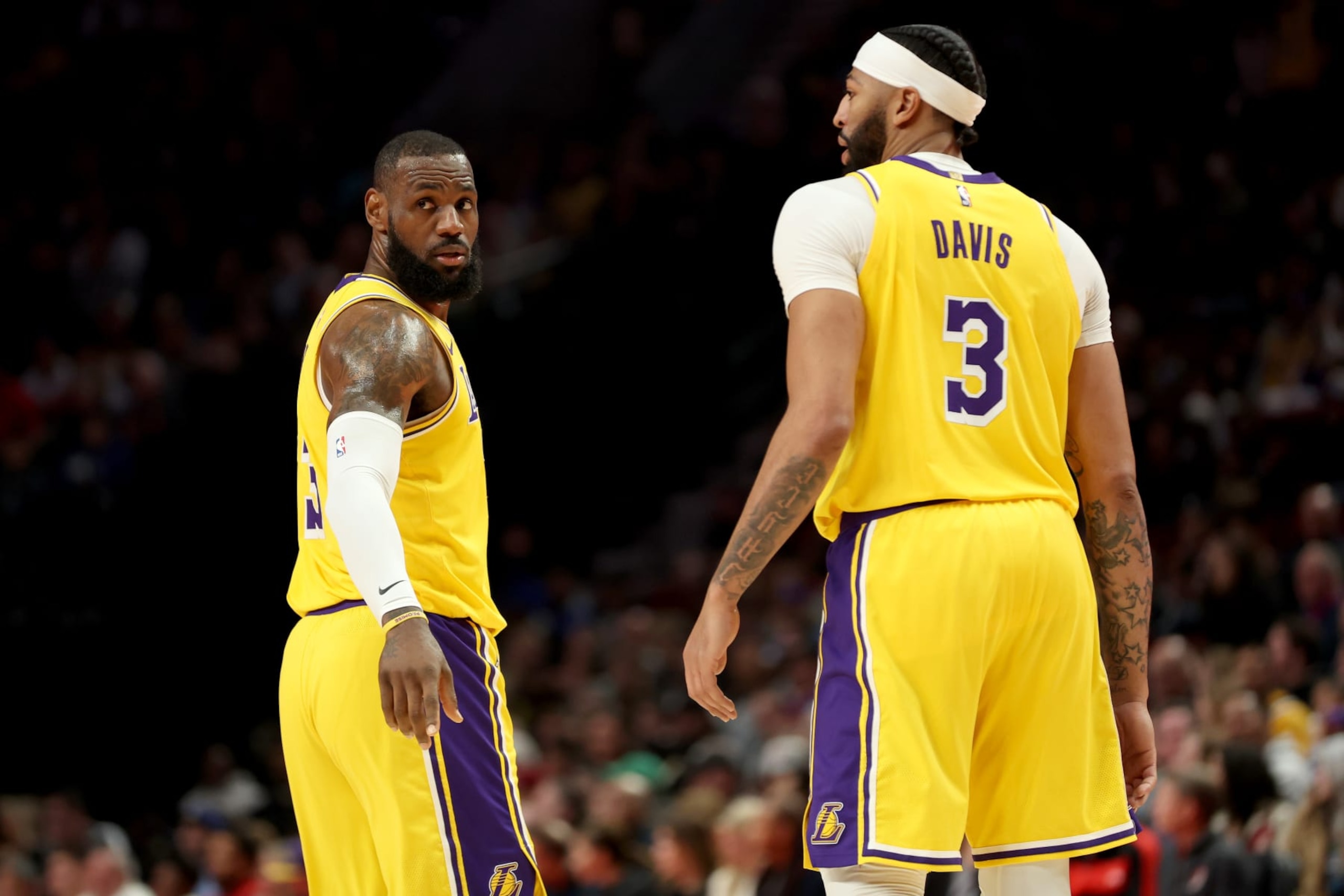 PORTLAND, OREGON - NOVEMBER 17: LeBron James #23 and Anthony Davis #3 of the Los Angeles Lakers react during the second quarter against the Portland Trail Blazers at Moda Center on November 17, 2023 in Portland, Oregon. NOTE TO USER: User expressly acknowledges and agrees that, by downloading and or using this photograph, User is consenting to the terms and conditions of the Getty Images License Agreement. (Photo by Steph Chambers/Getty Images)
