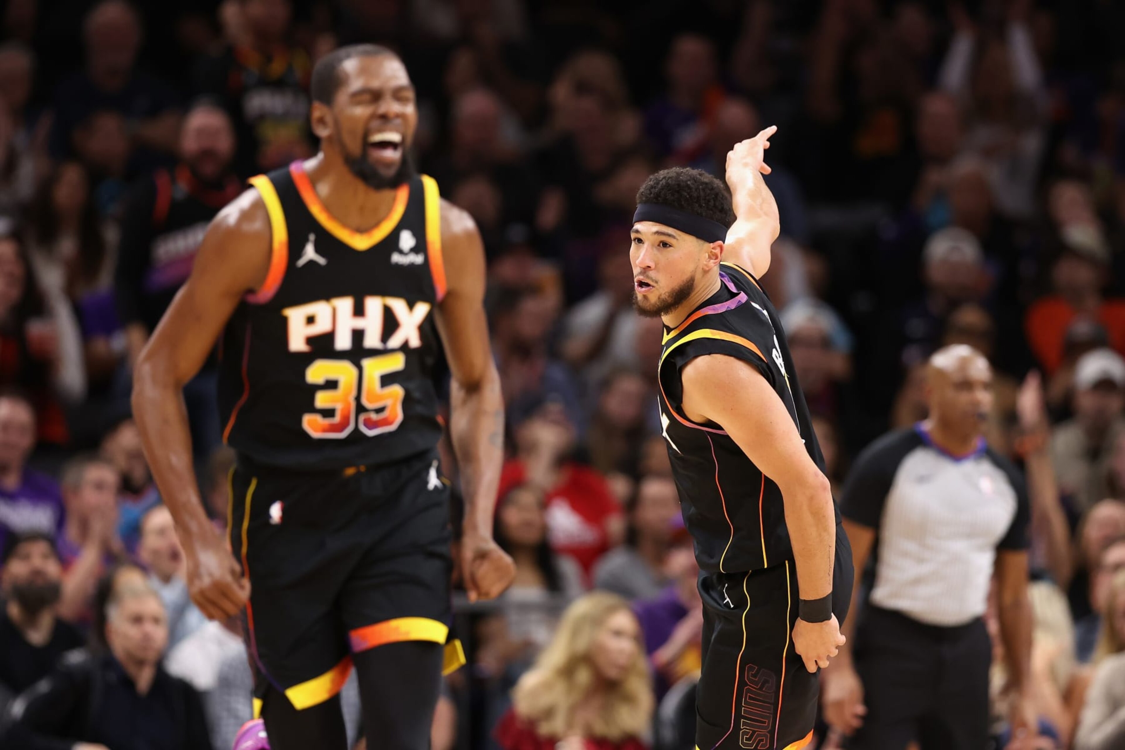 PHOENIX, ARIZONA - NOVEMBER 15: Devin Booker #1 of the Phoenix Suns reacts to a three-point shot against the Minnesota Timberwolves during the first half of the NBA game at Footprint Center on November 15, 2023 in Phoenix, Arizona. The Suns defeated the Timberwolves 133-115.  NOTE TO USER: User expressly acknowledges and agrees that, by downloading and or using this photograph, User is consenting to the terms and conditions of the Getty Images License Agreement.  (Photo by Christian Petersen/Getty Images)