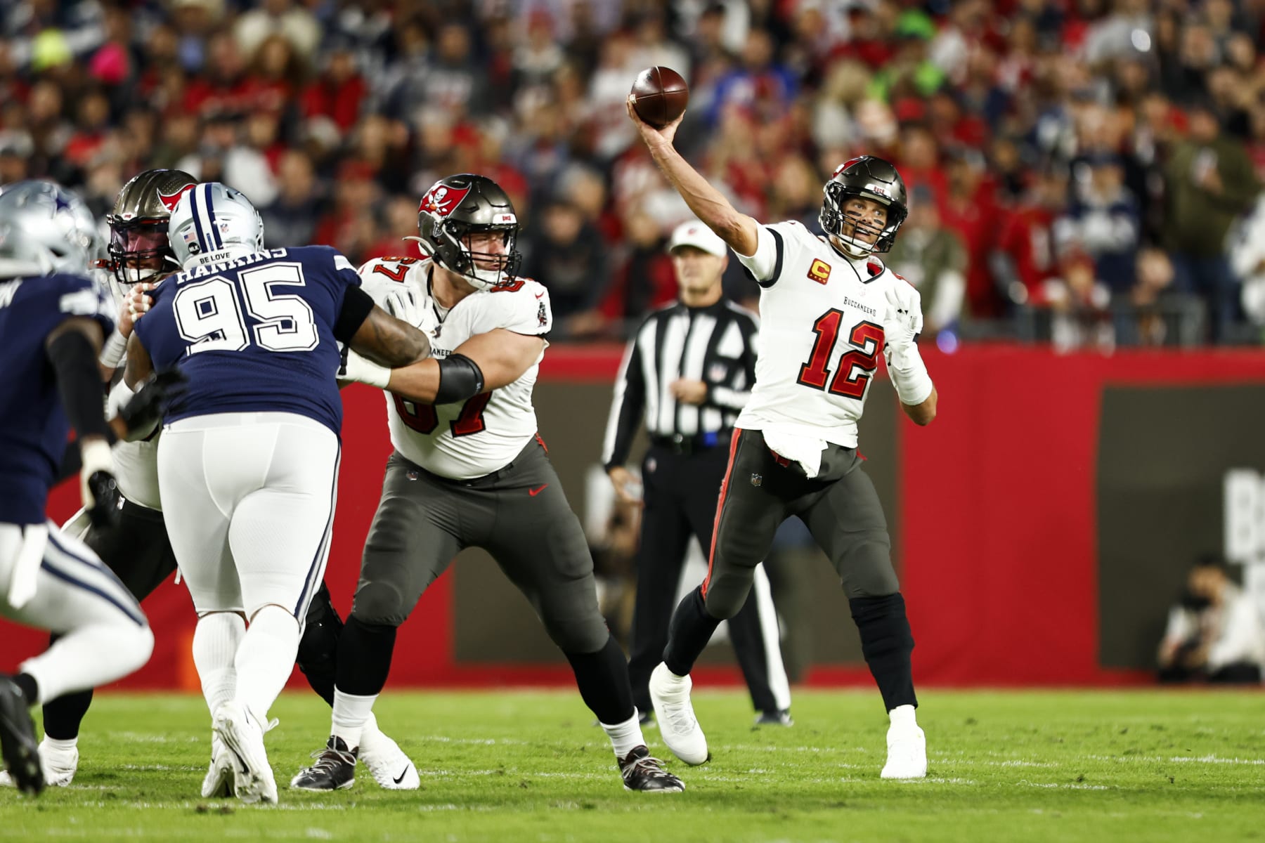 TAMPA, FL - JANUARY 16: Tom Brady #12 of the Tampa Bay Buccaneers throws a pass during an NFL wild card playoff football game against the Dallas Cowboys at Raymond James Stadium on January 16, 2023 in Tampa, Florida. (Photo by Kevin Sabitus/Getty Images)