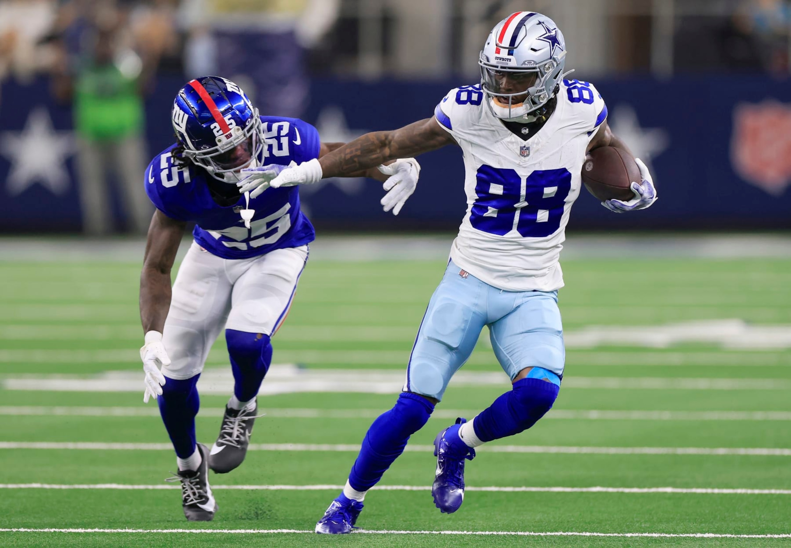 ARLINGTON, TEXAS - NOVEMBER 12: CeeDee Lamb #88 of the Dallas Cowboys runs with the ball against Deonte Banks #25 of the New York Giants during the second quarter at AT&T Stadium on November 12, 2023 in Arlington, Texas. (Photo by Ron Jenkins/Getty Images)
