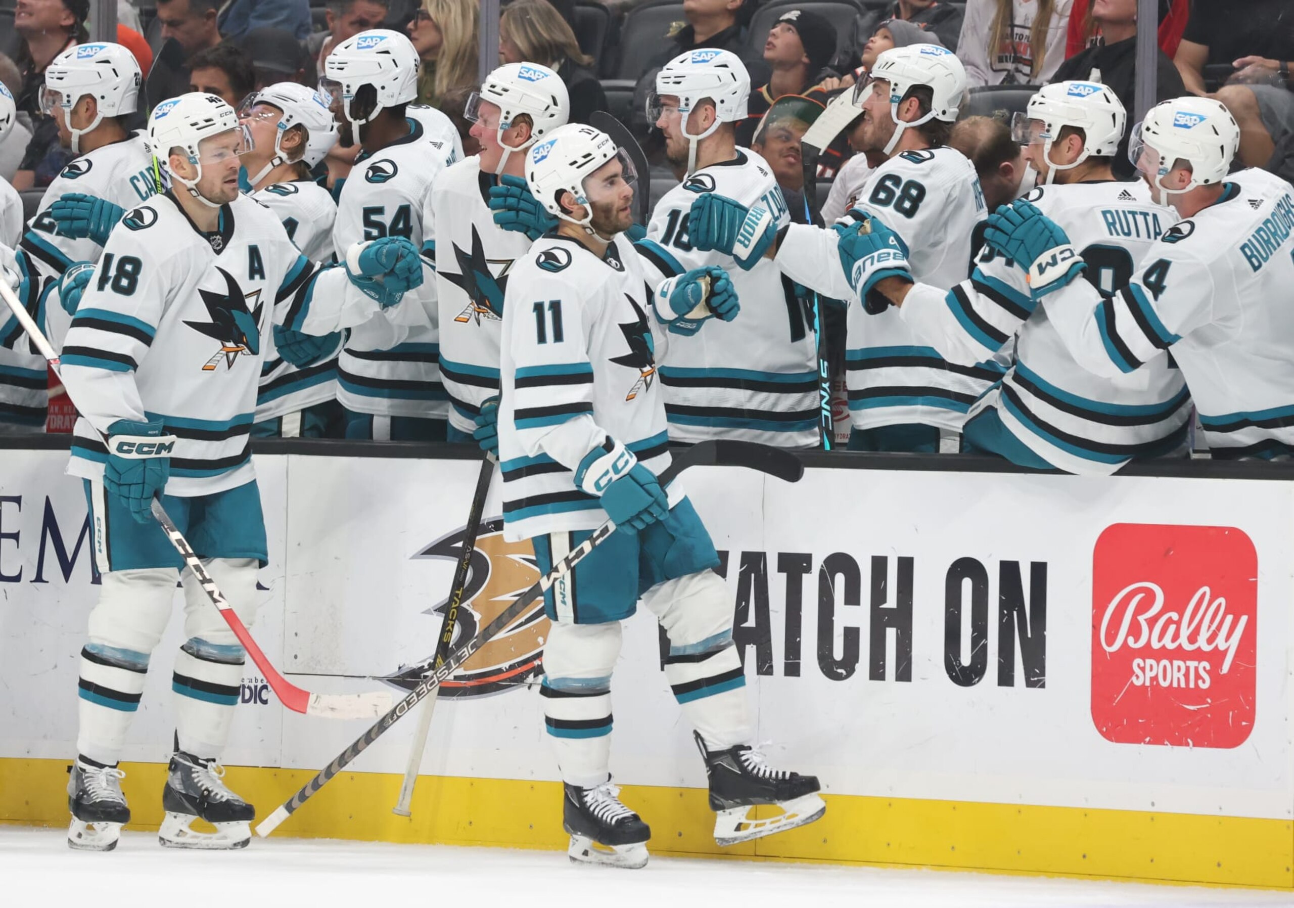 ANAHEIM, CA - NOVEMBER 12: Luke Kunin #11 of the San Jose Sharks celebrates his first-period goal with the bench during the game against the Anaheim Ducks at Honda Center on November 12, 2023 in Anaheim, California. (Photo by Debora Robinson/NHLI via Getty Images)