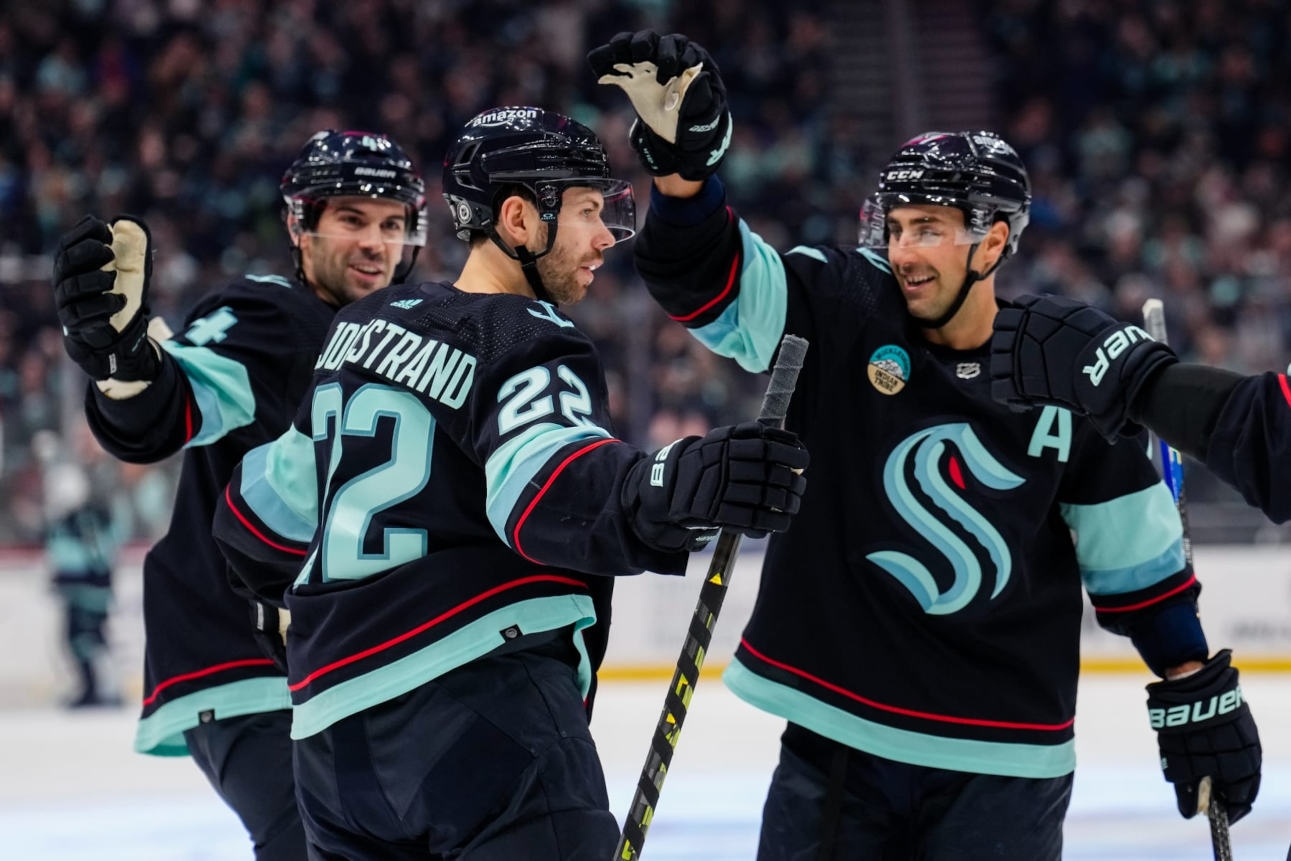 SEATTLE, WASHINGTON - NOVEMBER 04: Oliver Bjorkstrand #22 of the Seattle Kraken celebrates with teammates after scoring a goal during the first period of a game against the Calgary Flames at Climate Pledge Arena on November 4, 2023 in Seattle, Washington. (Photo by Christopher Mast/NHLI via Getty Images)