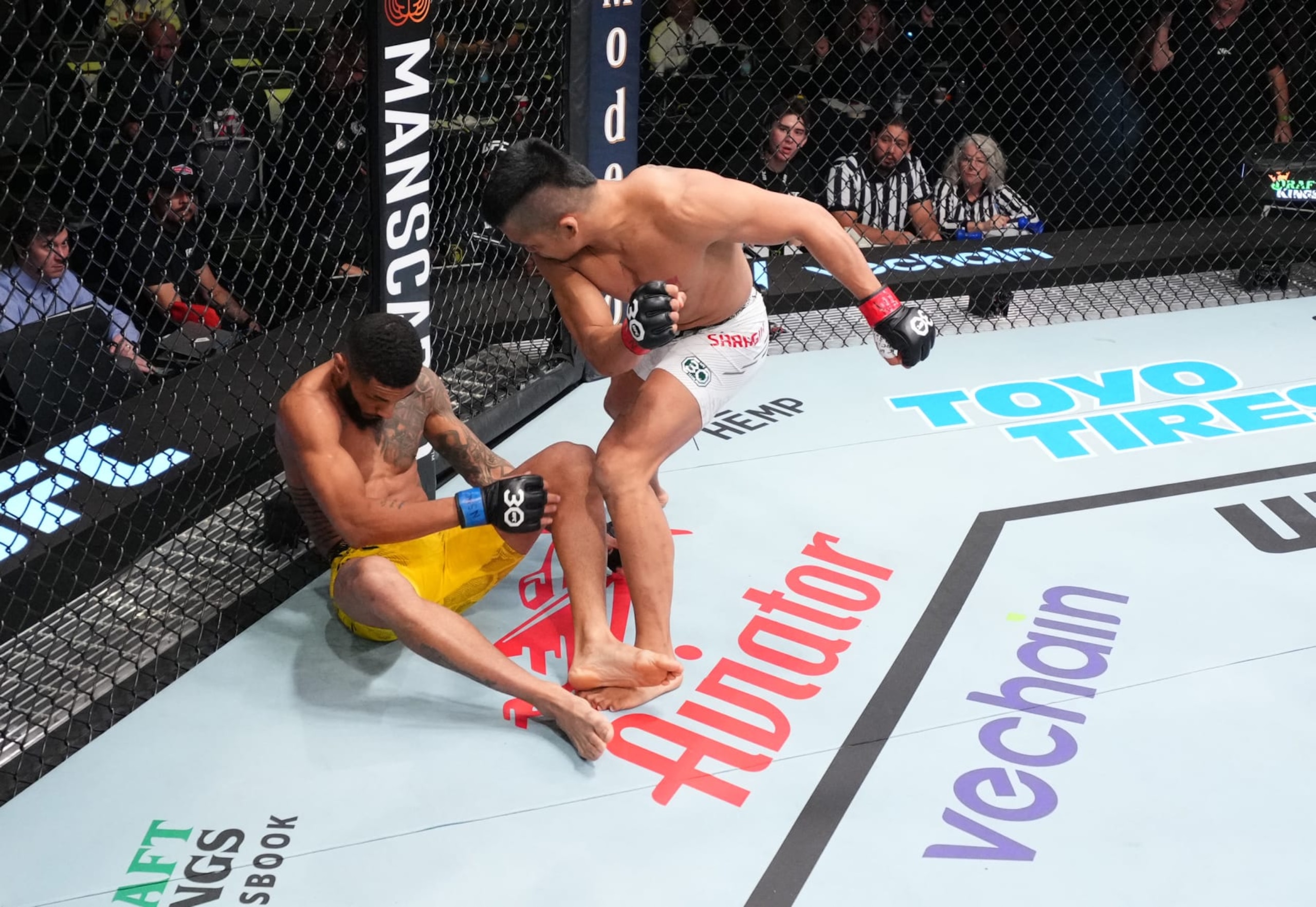 LAS VEGAS, NEVADA - NOVEMBER 18: (R-L) Jeka Saragih of Indonesia knocks out Lucas Alexander of Brazil in a featherweight fight during the UFC Fight Night event at UFC APEX on November 18, 2023 in Las Vegas, Nevada. (Photo by Chris Unger/Zuffa LLC via Getty Images)