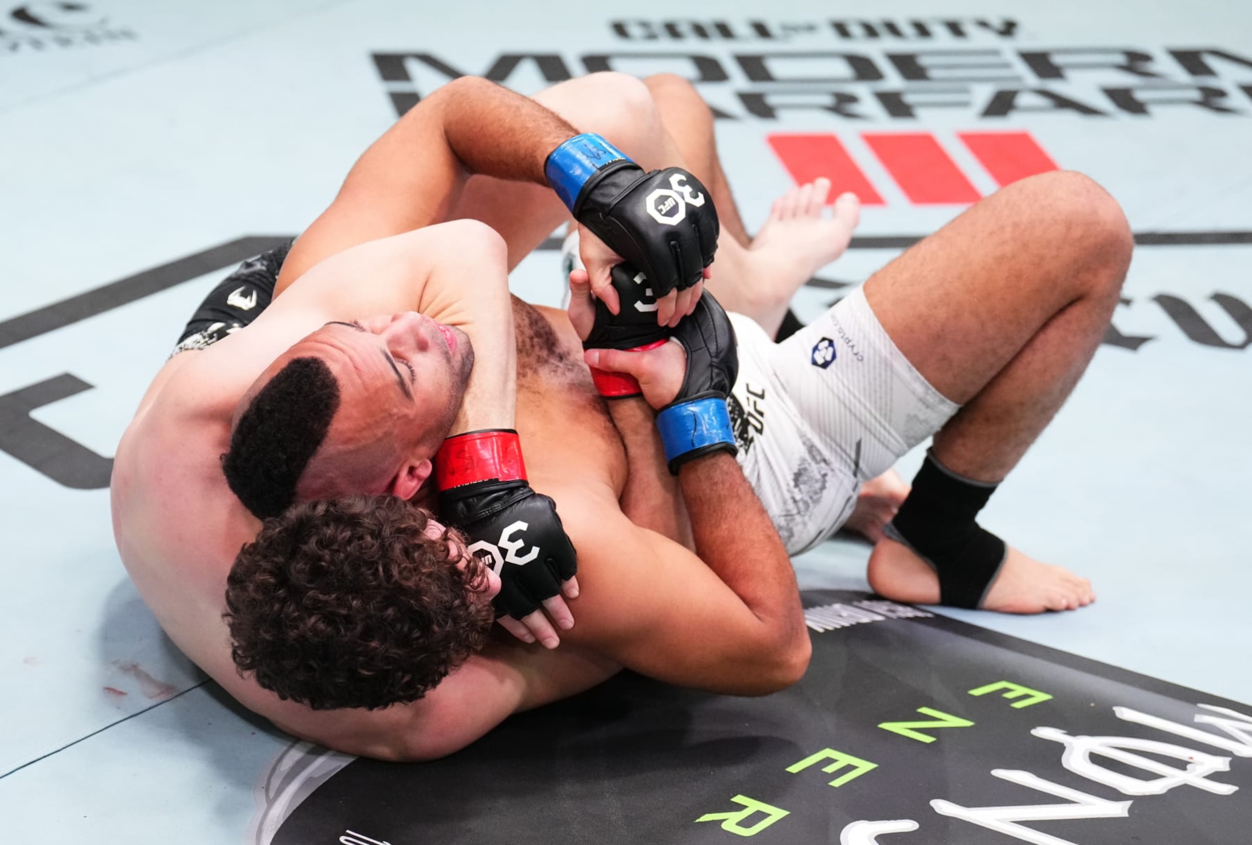 LAS VEGAS, NEVADA - NOVEMBER 18: (L-R) Chase Hooper secures a rear choke submission against Jordan Leavitt in a lightweight fight during the UFC Fight Night event at UFC APEX on November 18, 2023 in Las Vegas, Nevada. (Photo by Chris Unger/Zuffa LLC via Getty Images)