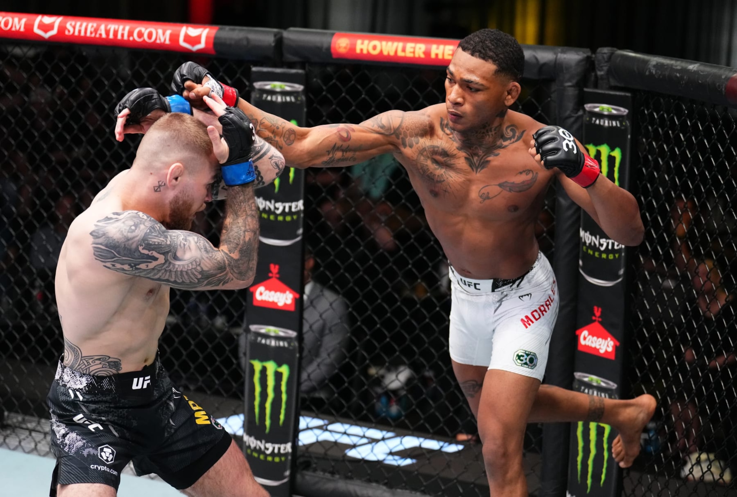 LAS VEGAS, NEVADA - NOVEMBER 18: (R-L) Michael Morales of Ecuador punches Jake Matthews of Australia in a welterweight fight during the UFC Fight Night event at UFC APEX on November 18, 2023 in Las Vegas, Nevada. (Photo by Chris Unger/Zuffa LLC via Getty Images)