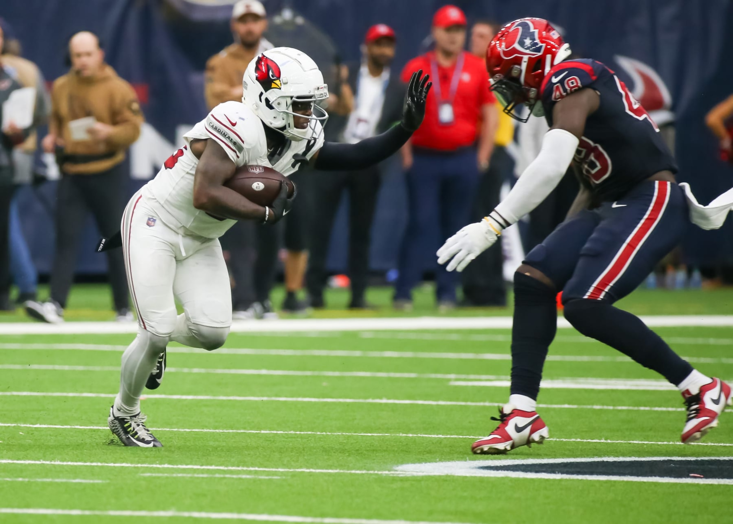 HOUSTON, TX - NOVEMBER 19:  Arizona Cardinals wide receiver Greg Dortch (83) stiff arms Houston Texans linebacker Christian Harris (48) in the fourth quarter during the NFL game between the Arizona Cardinals and Houston Texans on November 19, 2023 at NRG Stadium in Houston, Texas.  (Photo by Leslie Plaza Johnson/Icon Sportswire via Getty Images)