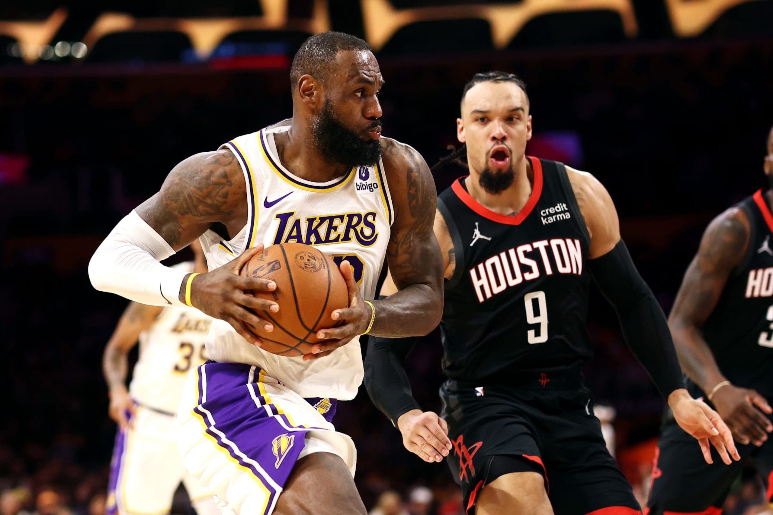 LOS ANGELES, CALIFORNIA - NOVEMBER 19: LeBron James #23 of the Los Angeles Lakers drives to the basket against Dillon Brooks #9 of the Houston Rockets during the first quarter at Crypto.com Arena on November 19, 2023 in Los Angeles, California. NOTE TO USER: User expressly acknowledges and agrees that, by downloading and or using this photograph, User is consenting to the terms and conditions of the Getty Images License Agreement. (Photo by Katelyn Mulcahy/Getty Images)
