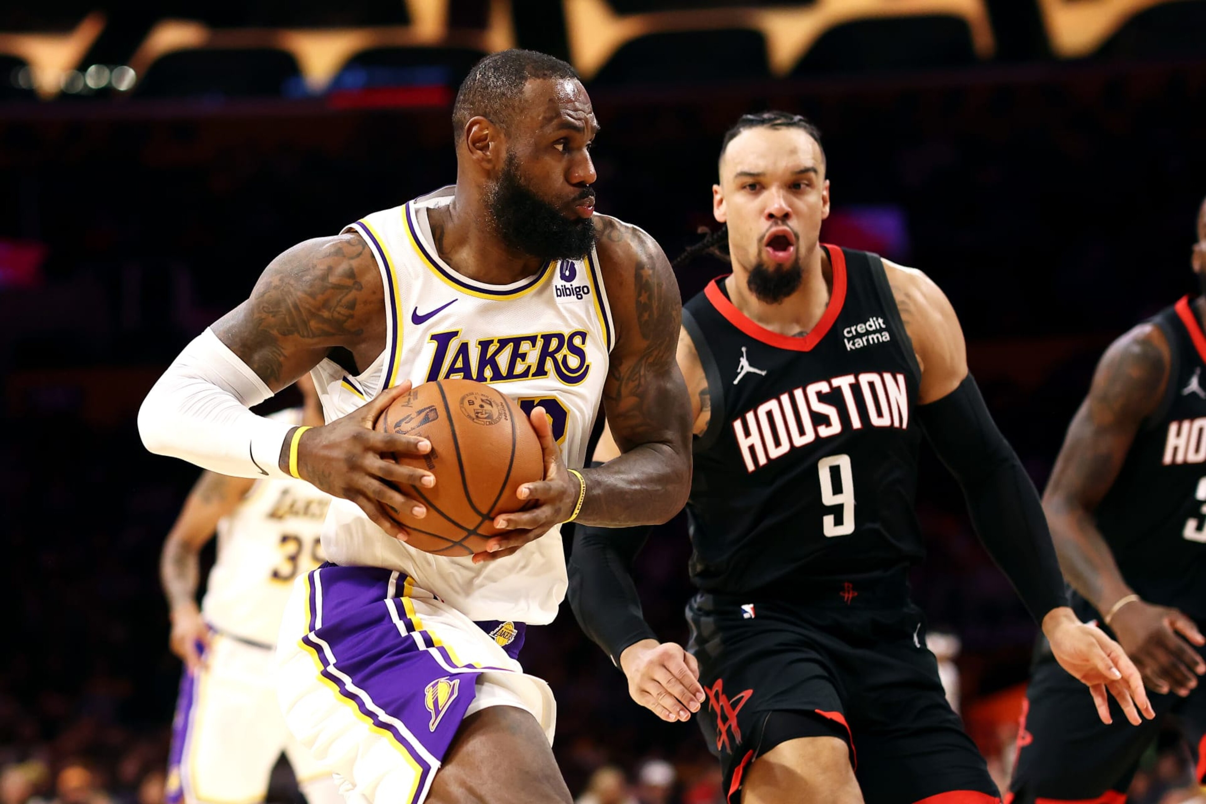 LOS ANGELES, CALIFORNIA - NOVEMBER 19: LeBron James #23 of the Los Angeles Lakers drives to the basket against Dillon Brooks #9 of the Houston Rockets during the first quarter at Crypto.com Arena on November 19, 2023 in Los Angeles, California. NOTE TO USER: User expressly acknowledges and agrees that, by downloading and or using this photograph, User is consenting to the terms and conditions of the Getty Images License Agreement. (Photo by Katelyn Mulcahy/Getty Images)