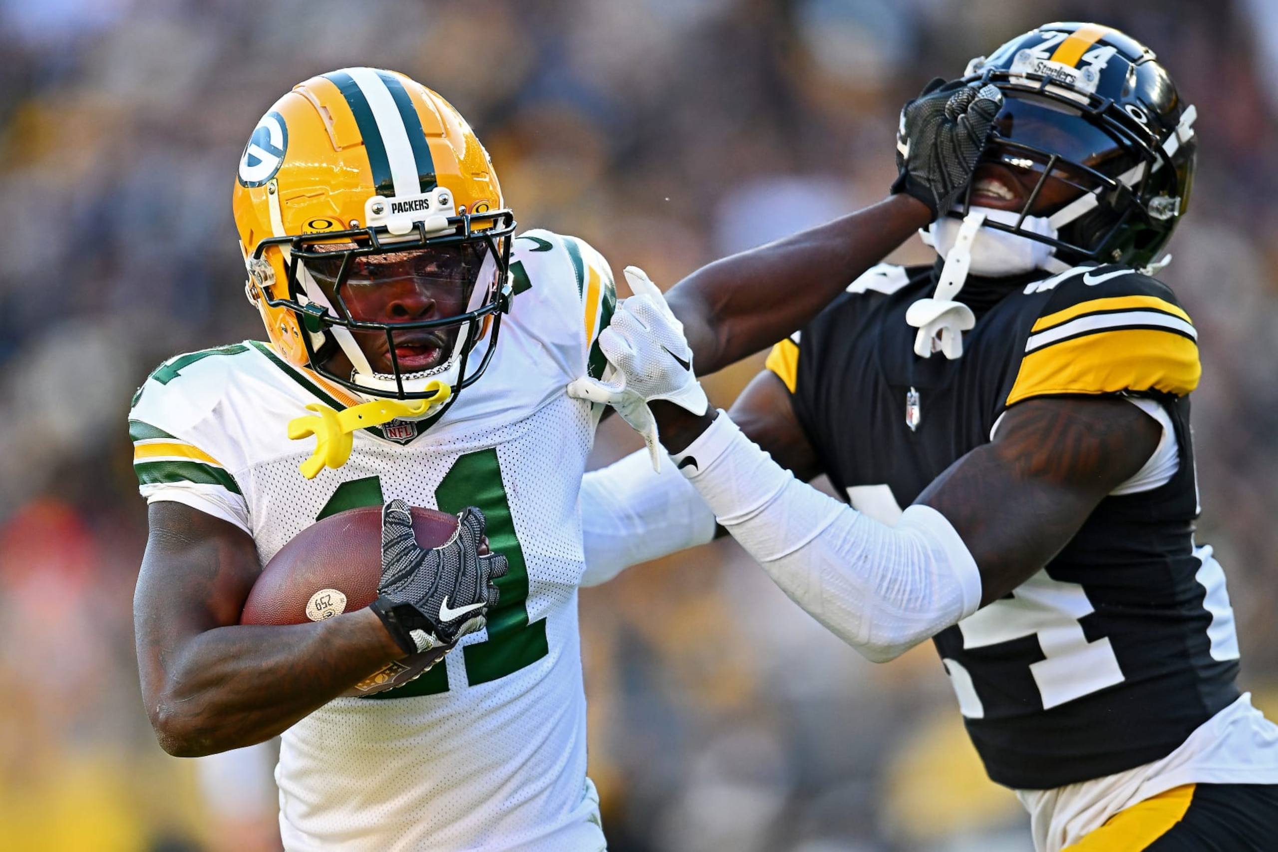 PITTSBURGH, PENNSYLVANIA - NOVEMBER 12: Jayden Reed #11 of the Green Bay Packers stiff arms Joey Porter Jr. #24 of the Pittsburgh Steelers during the third quarter at Acrisure Stadium on November 12, 2023 in Pittsburgh, Pennsylvania. (Photo by Joe Sargent/Getty Images)