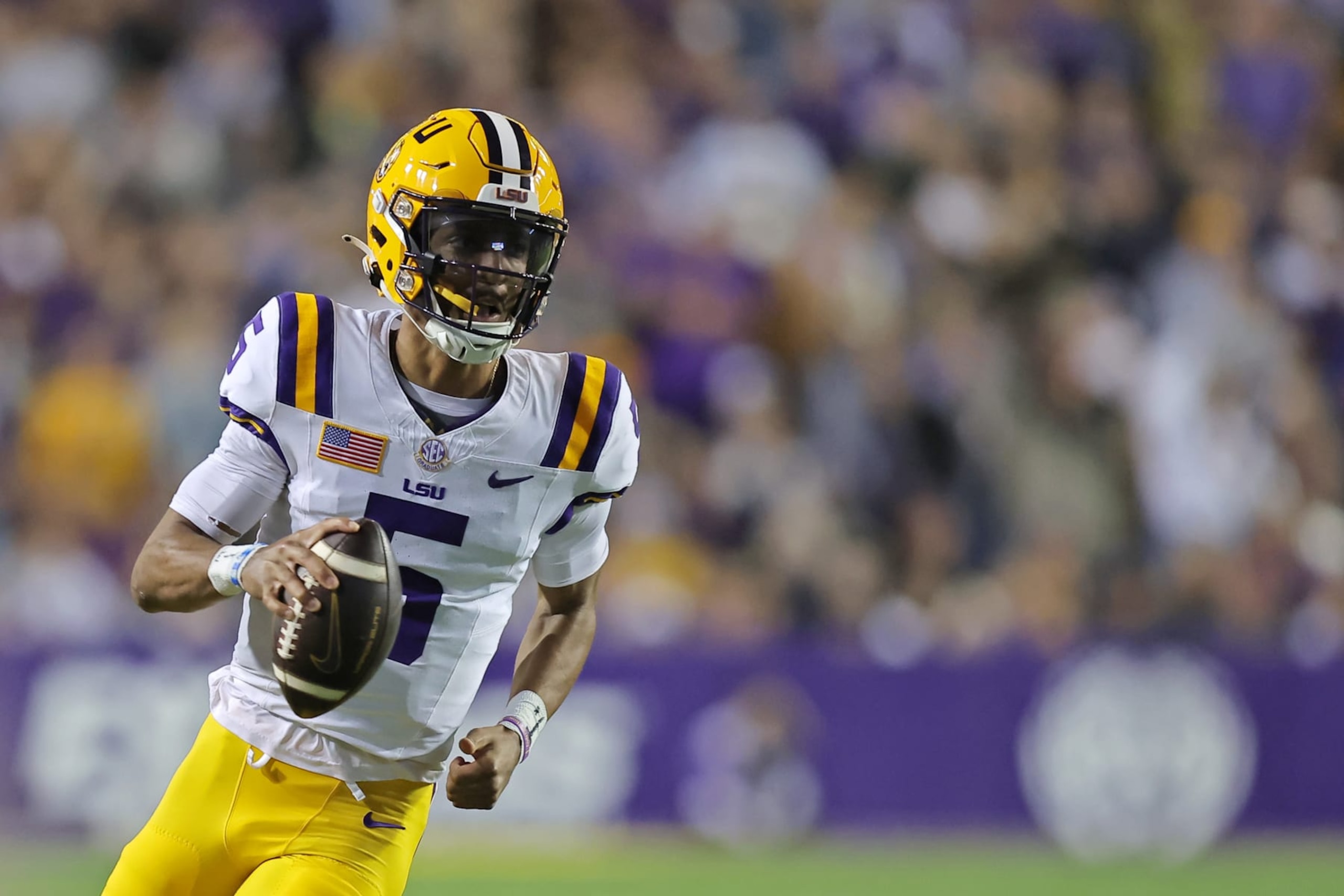 BATON ROUGE, LOUISIANA - NOVEMBER 11: Jayden Daniels #5 of the LSU Tigers runs with the ball against the Florida Gators during a game at Tiger Stadium on November 11, 2023 in Baton Rouge, Louisiana. (Photo by Jonathan Bachman/Getty Images)