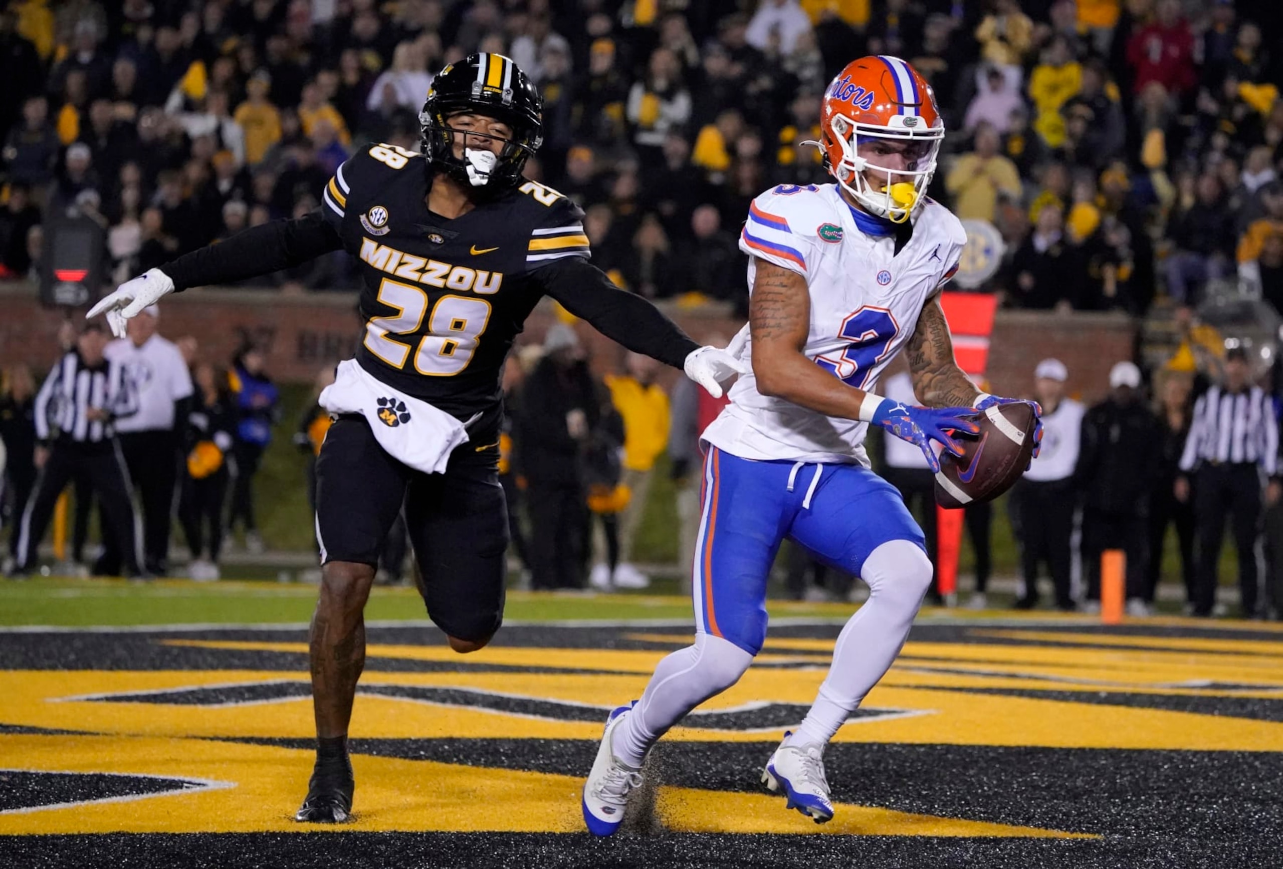 COLUMBIA, MISSOURI - NOVEMBER 18: Wide receiver Eugene Wilson III #3 of the Florida Gators catches a pass for a touchdown against defensive back Joseph Charleston #28 of the Missouri Tigers in the first half at Faurot Field/Memorial Stadium on November 18, 2023 in Columbia, Missouri. (Photo by Ed Zurga/Getty Images)