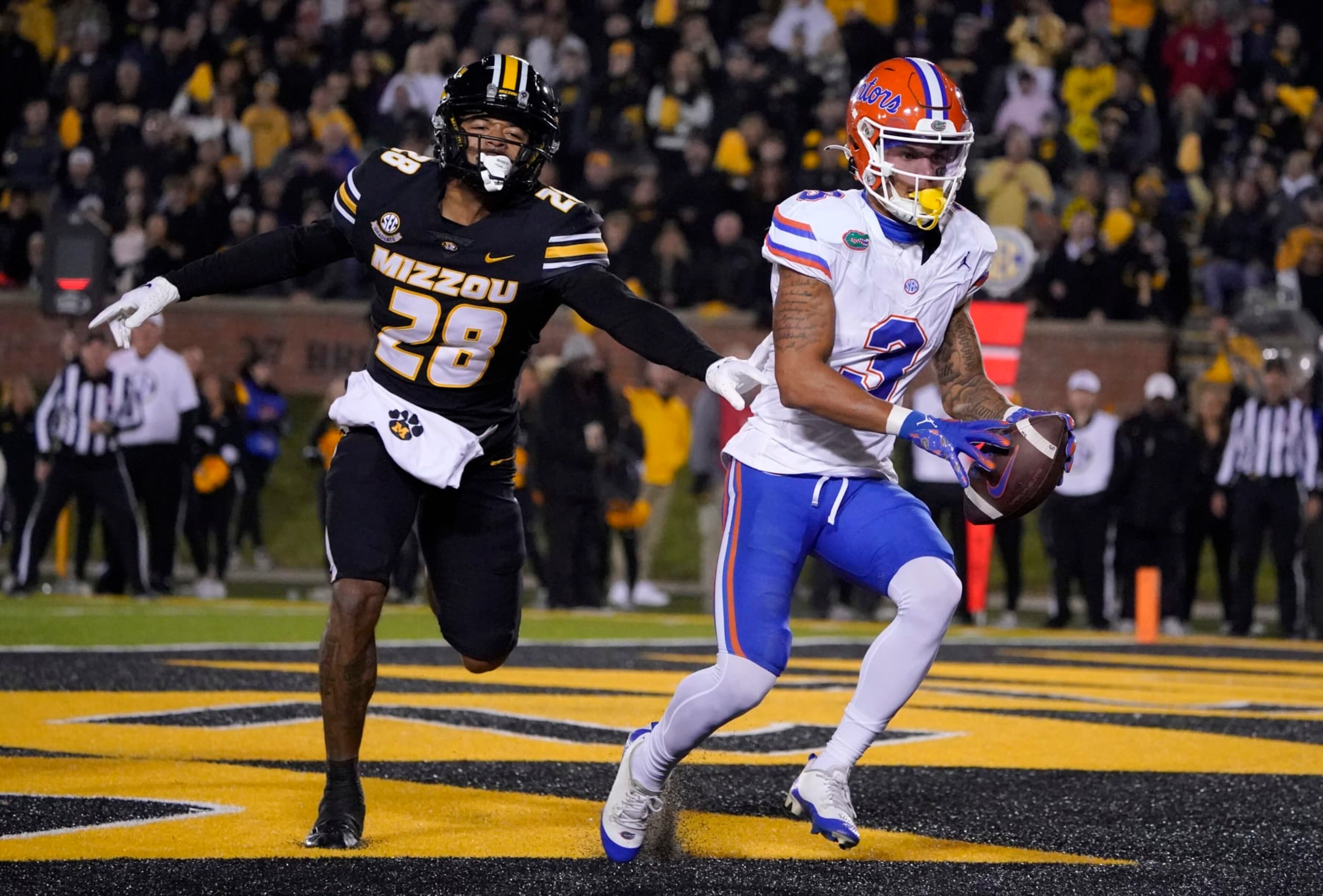 COLUMBIA, MISSOURI - NOVEMBER 18: Wide receiver Eugene Wilson III #3 of the Florida Gators catches a pass for a touchdown against defensive back Joseph Charleston #28 of the Missouri Tigers in the first half at Faurot Field/Memorial Stadium on November 18, 2023 in Columbia, Missouri. (Photo by Ed Zurga/Getty Images)