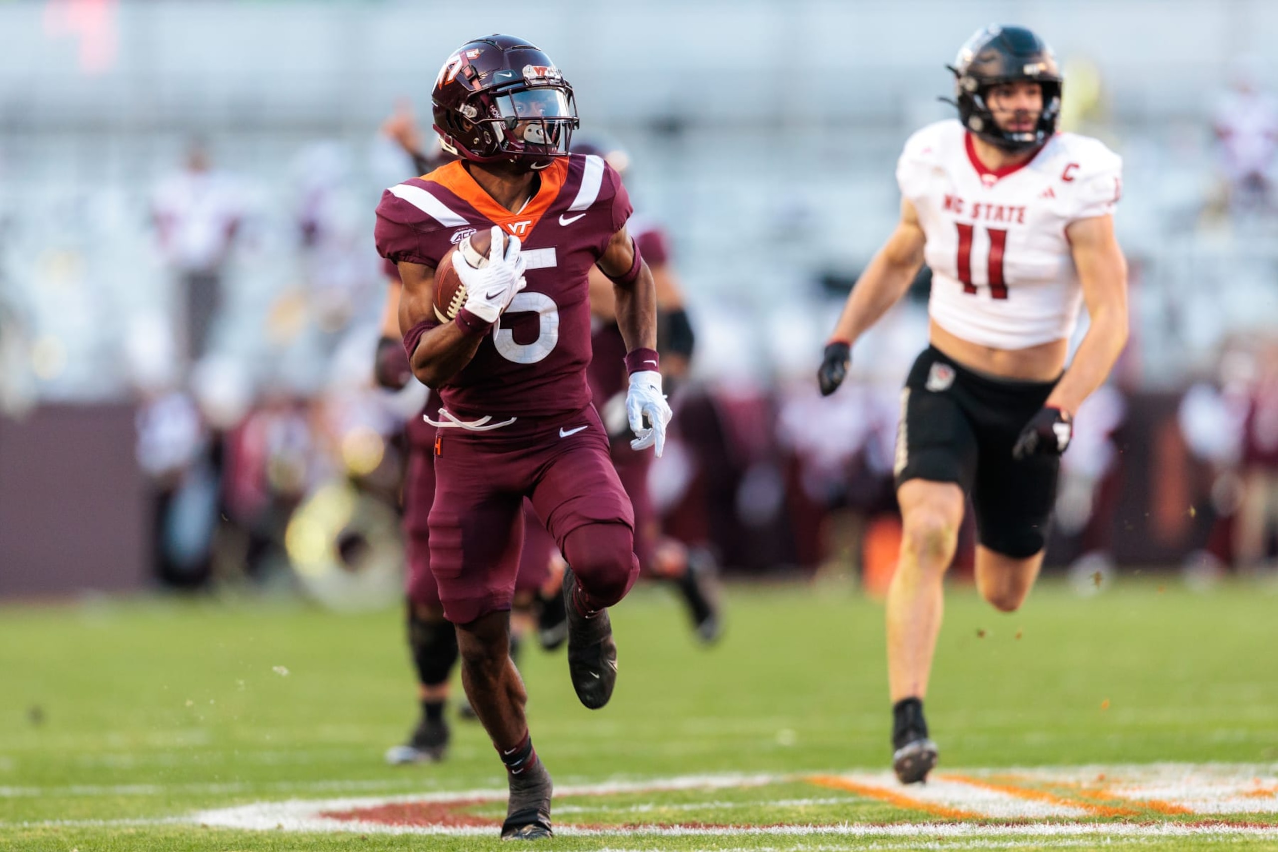 BLACKSBURG, VIRGINIA - NOVEMBER 18: Xayvion Turner-Bradshaw #5 of the Virginia Tech Hokies runs the ball for a touchdown against the NC State Wolfpack in the first half during a game at Lane Stadium on November 18, 2023 in Blacksburg, Virginia. (Photo by Ryan Hunt/Getty Images)