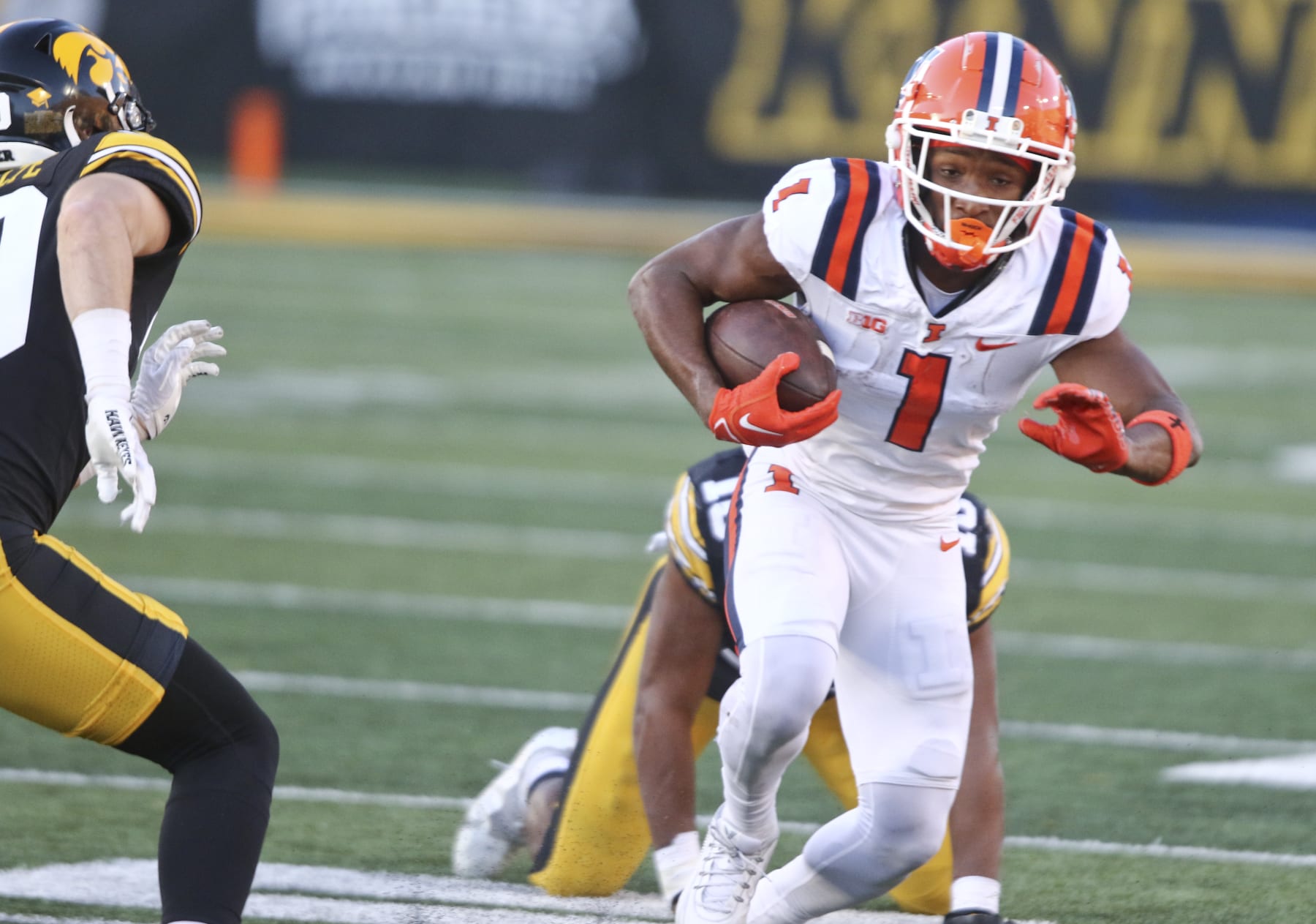 IOWA CITY, IOWA- NOVEMBER 18:  Wide receiver Isaiah Williams #1 of the Illinois Fighting Illini goes up the field during the first half in front of linebacker Nick Jackson #10 of the Iowa Hawkeyes at Kinnick Stadium on November 18, 2023 in Iowa City, Iowa.  (Photo by Matthew Holst/Getty Images)