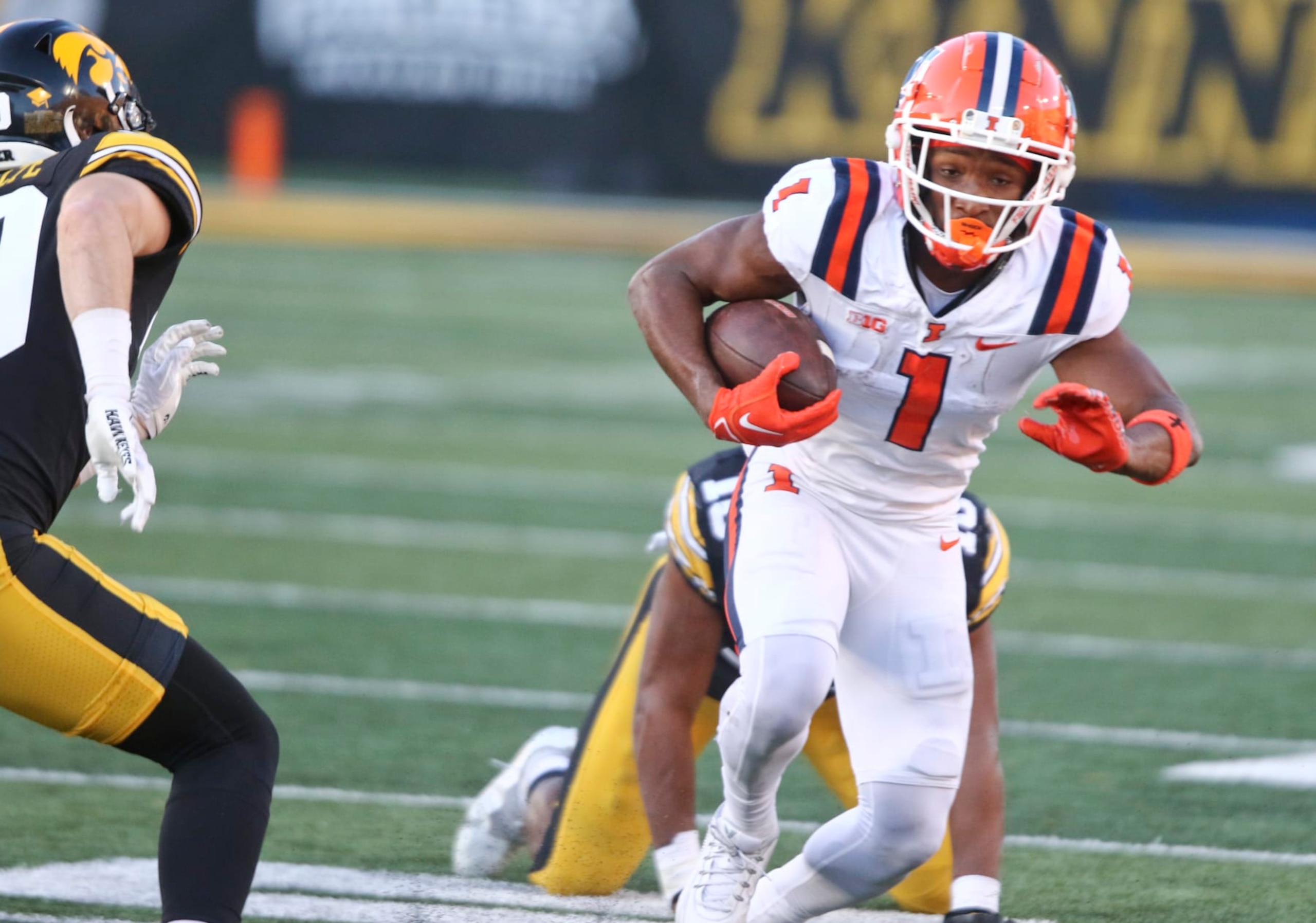 IOWA CITY, IOWA- NOVEMBER 18:  Wide receiver Isaiah Williams #1 of the Illinois Fighting Illini goes up the field during the first half in front of linebacker Nick Jackson #10 of the Iowa Hawkeyes at Kinnick Stadium on November 18, 2023 in Iowa City, Iowa.  (Photo by Matthew Holst/Getty Images)